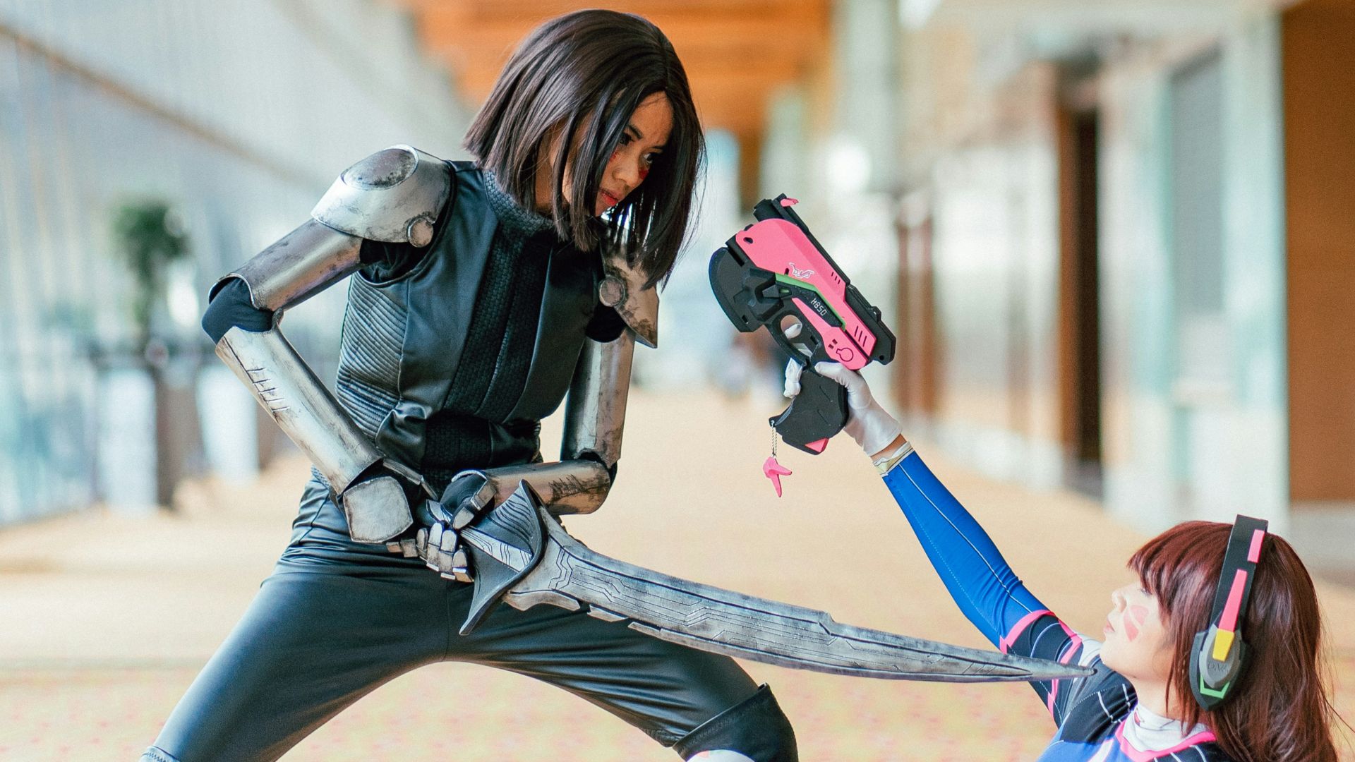 woman pointing sword to another woman