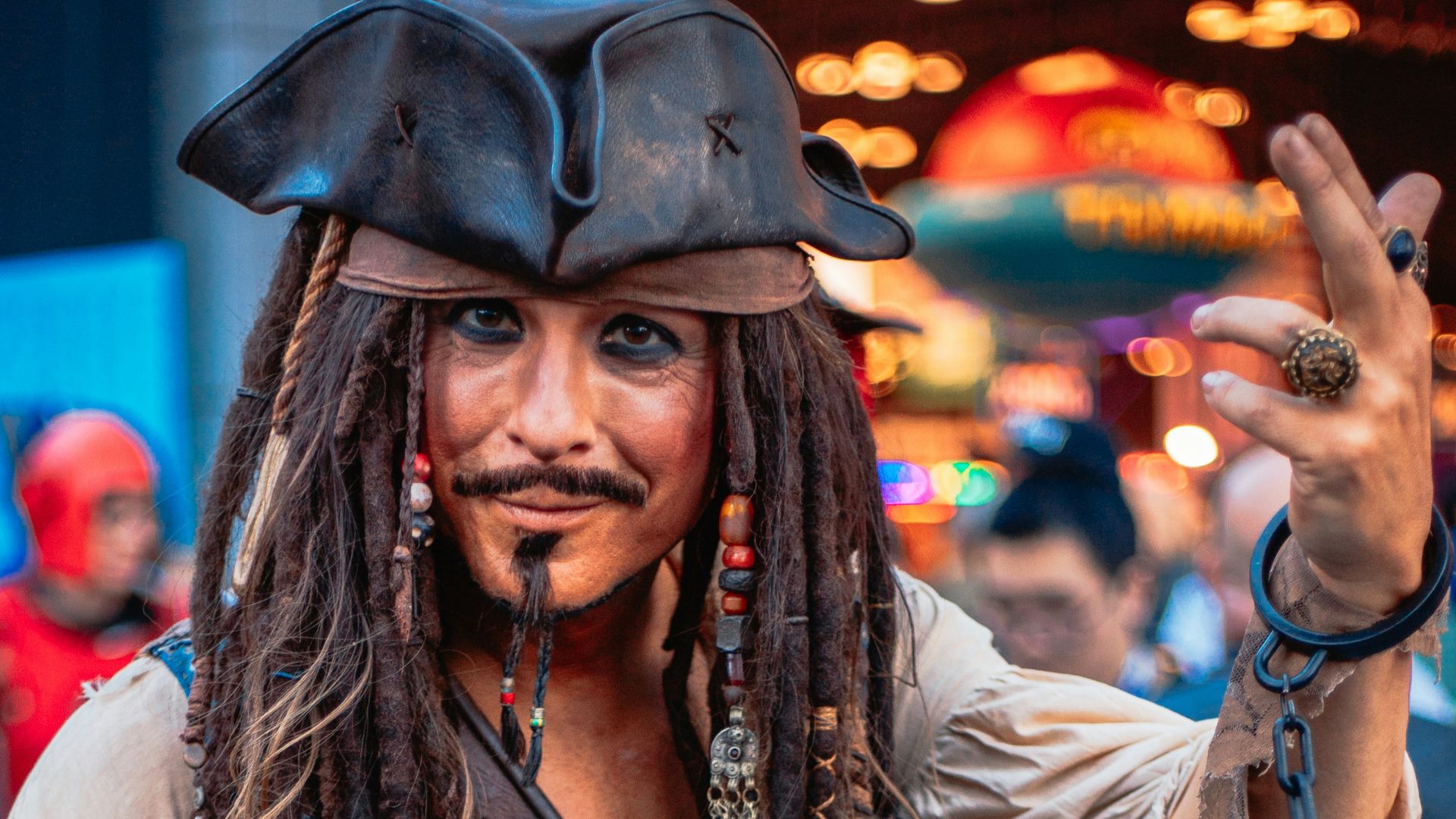A man with dreadlocks and a pirate costume