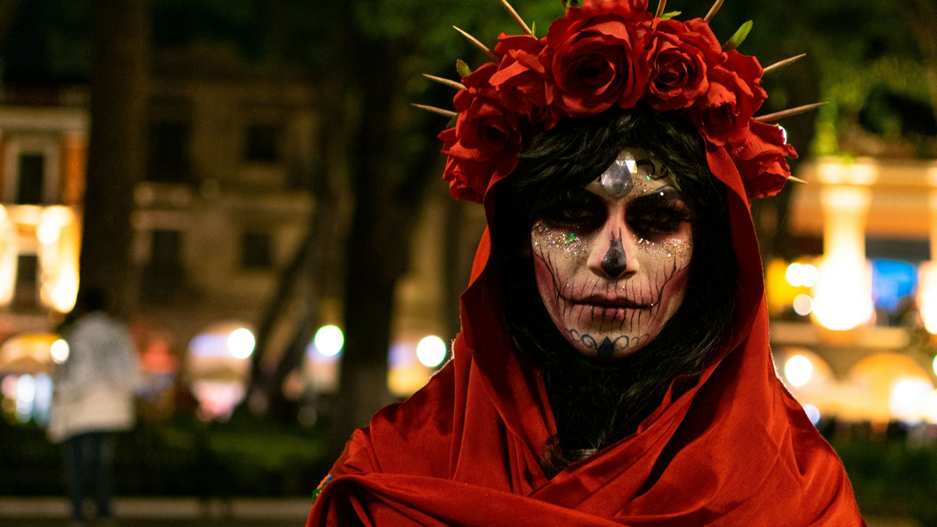 a woman with makeup and flowers on her head