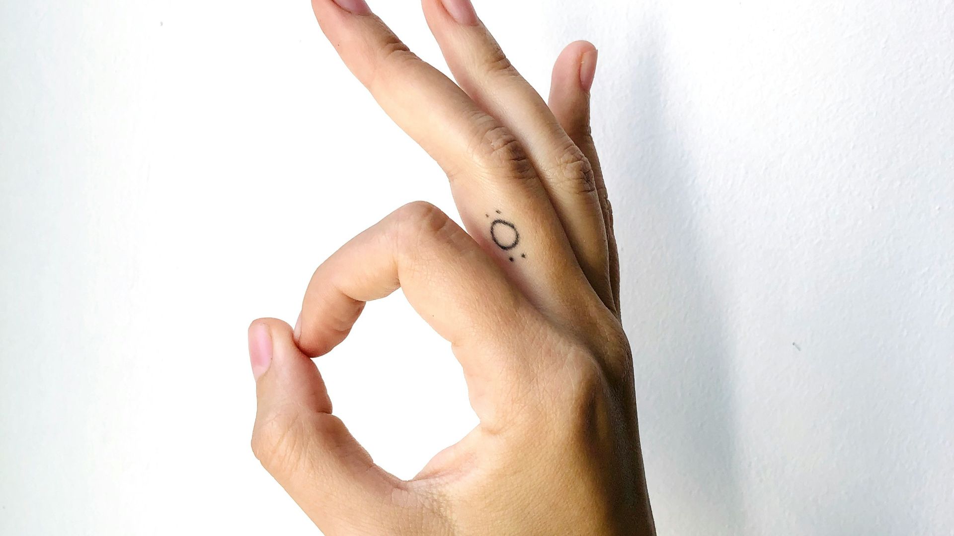 persons left hand on white surface