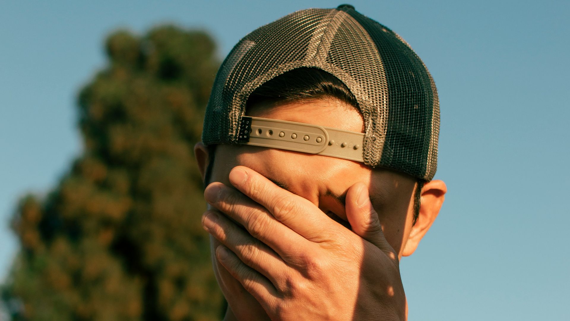 man covering his face