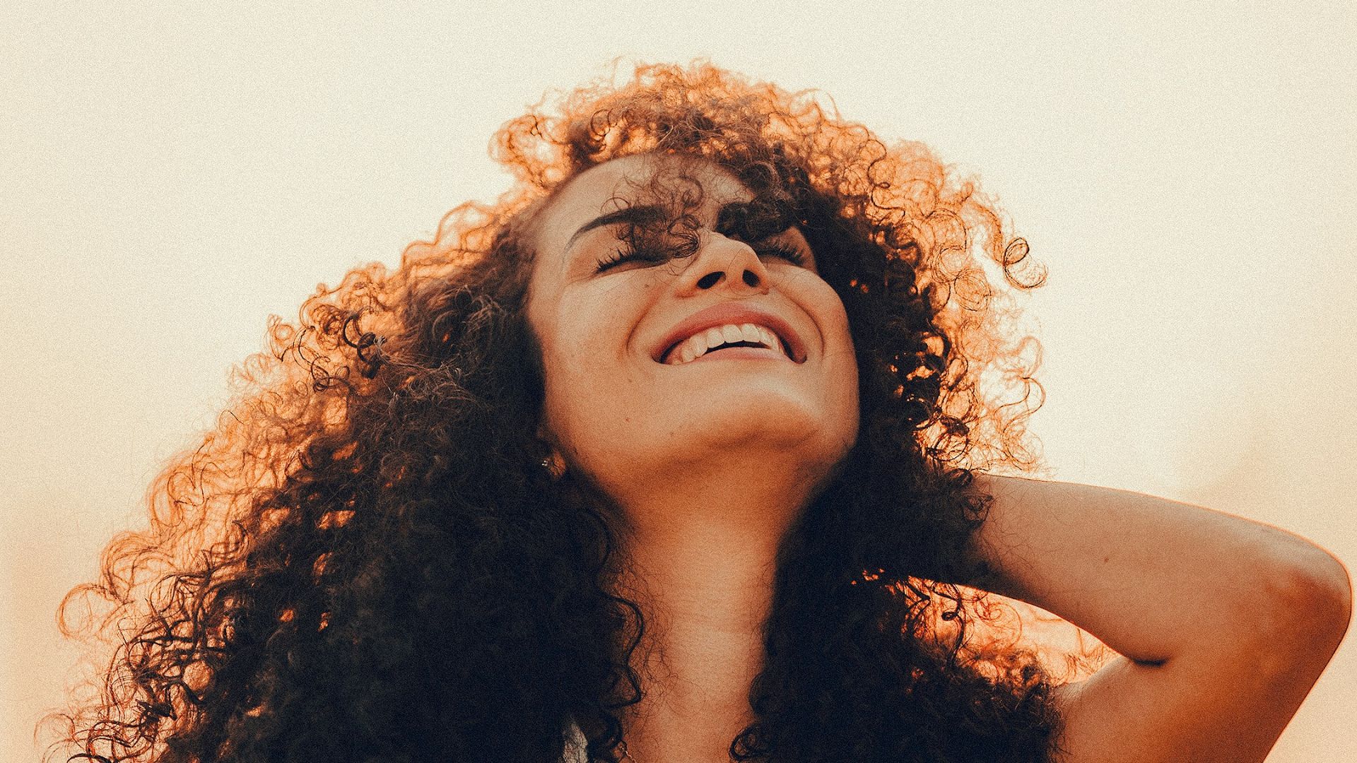 a woman with pink hair looking at the camera