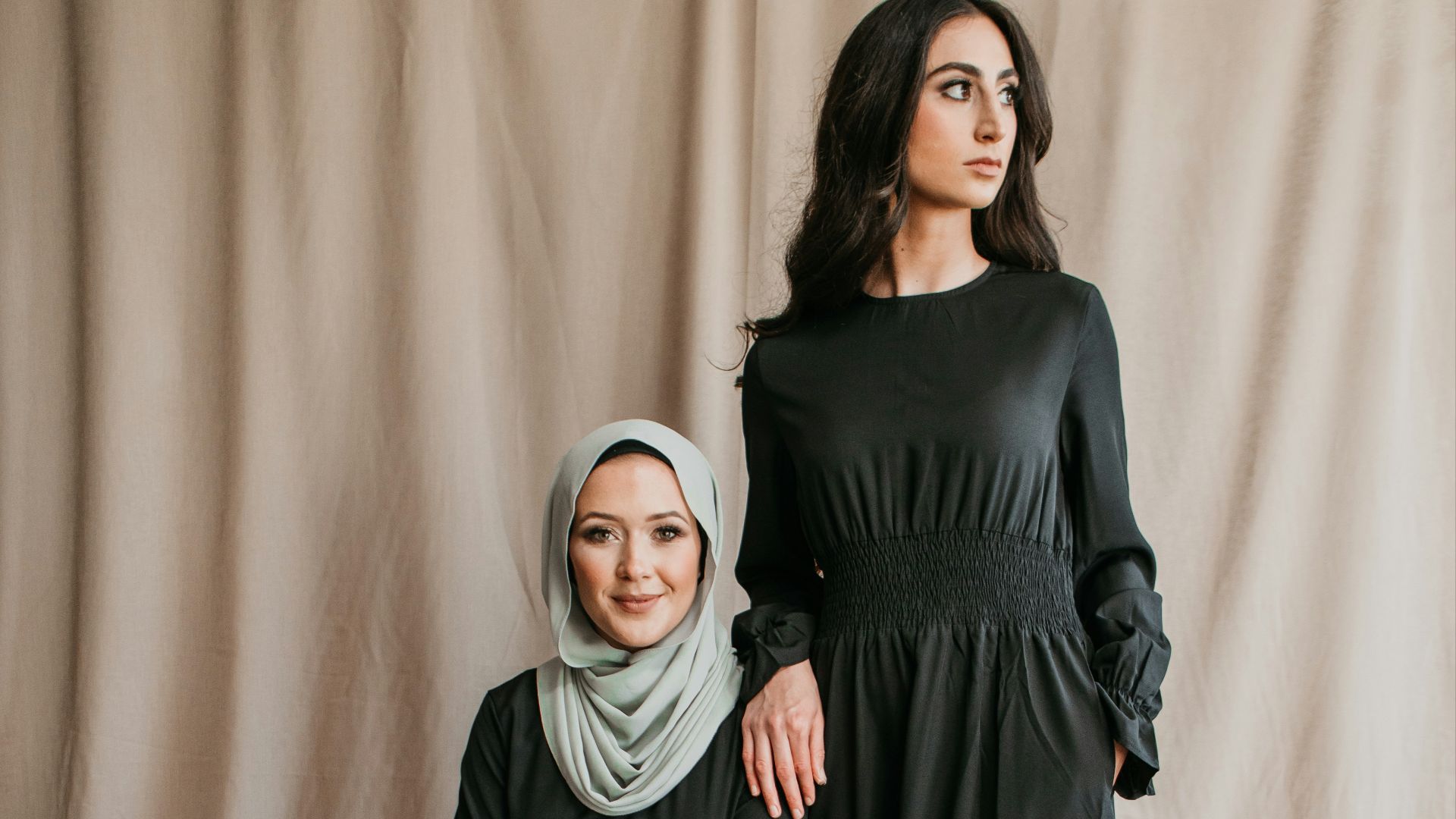 two women in black dresses