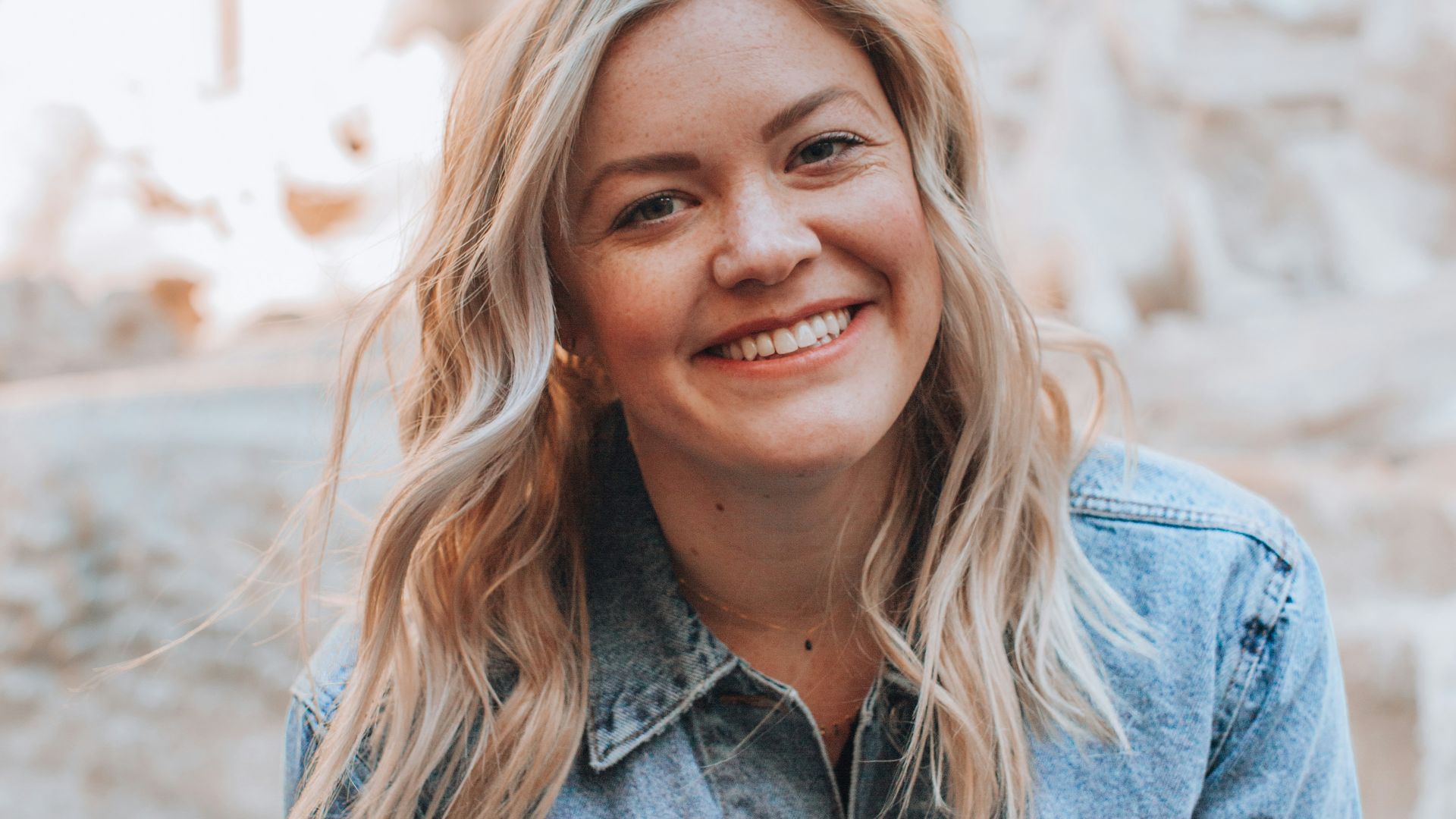 woman smiling wearing denim jacket