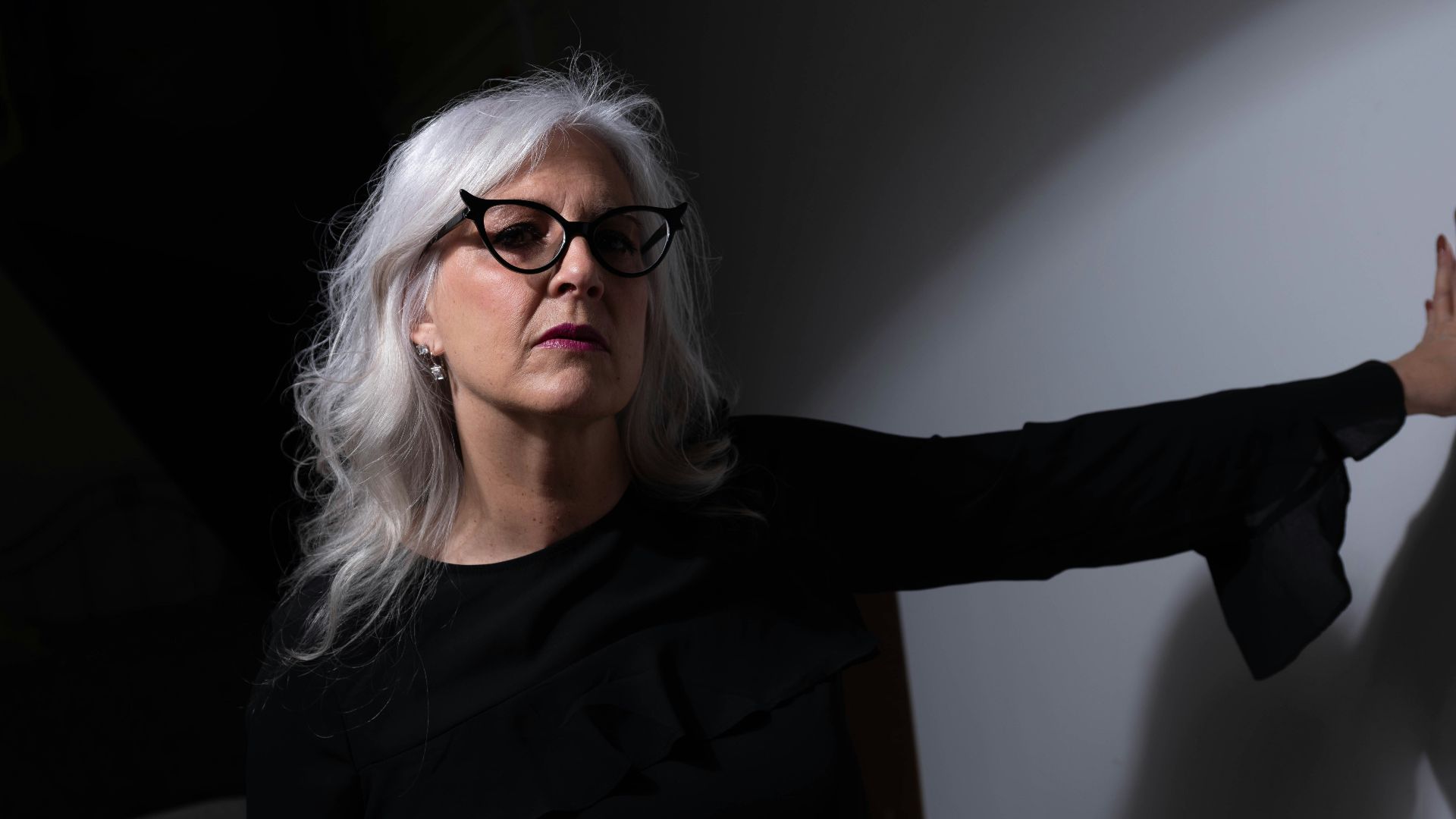 woman in black long sleeve shirt wearing eyeglasses