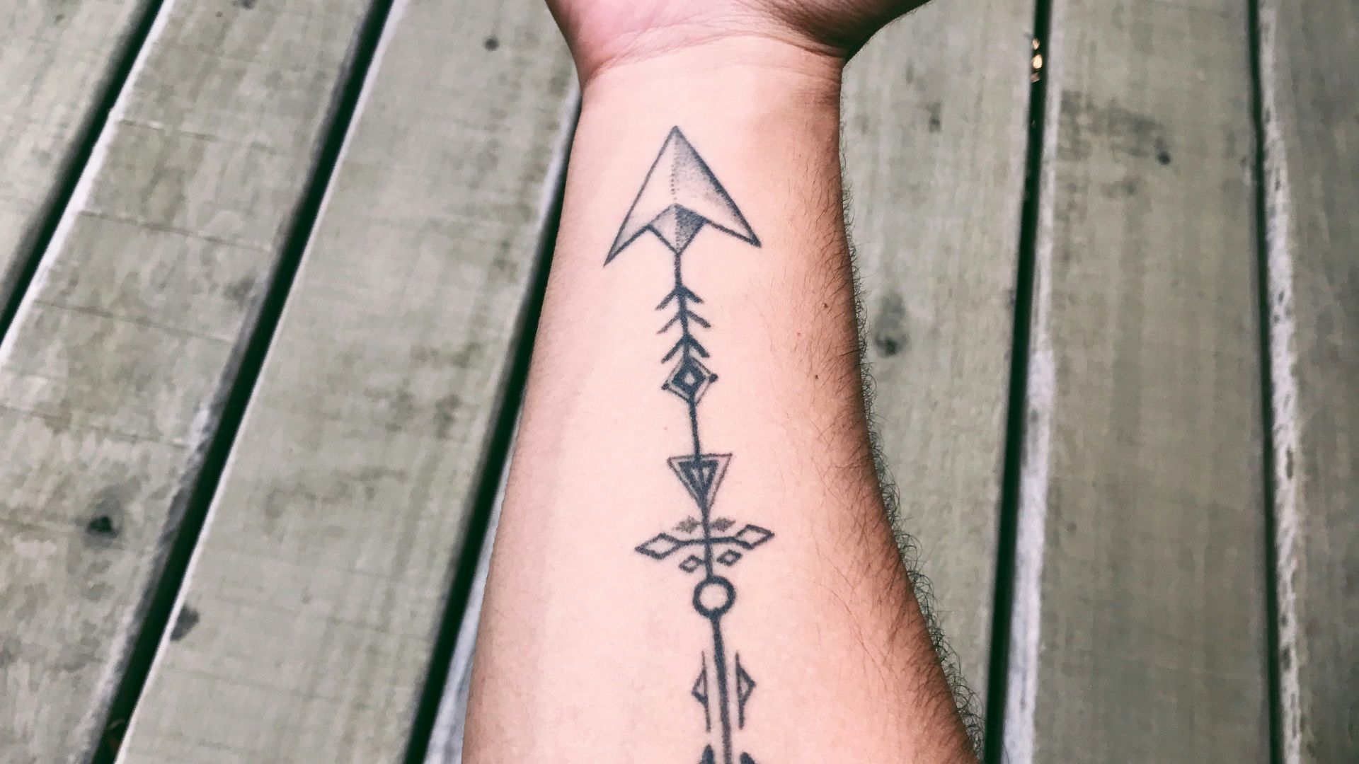 black tattoo on persons left hand