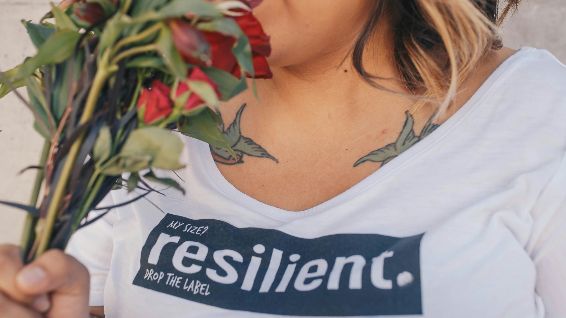 woman smelling red roses