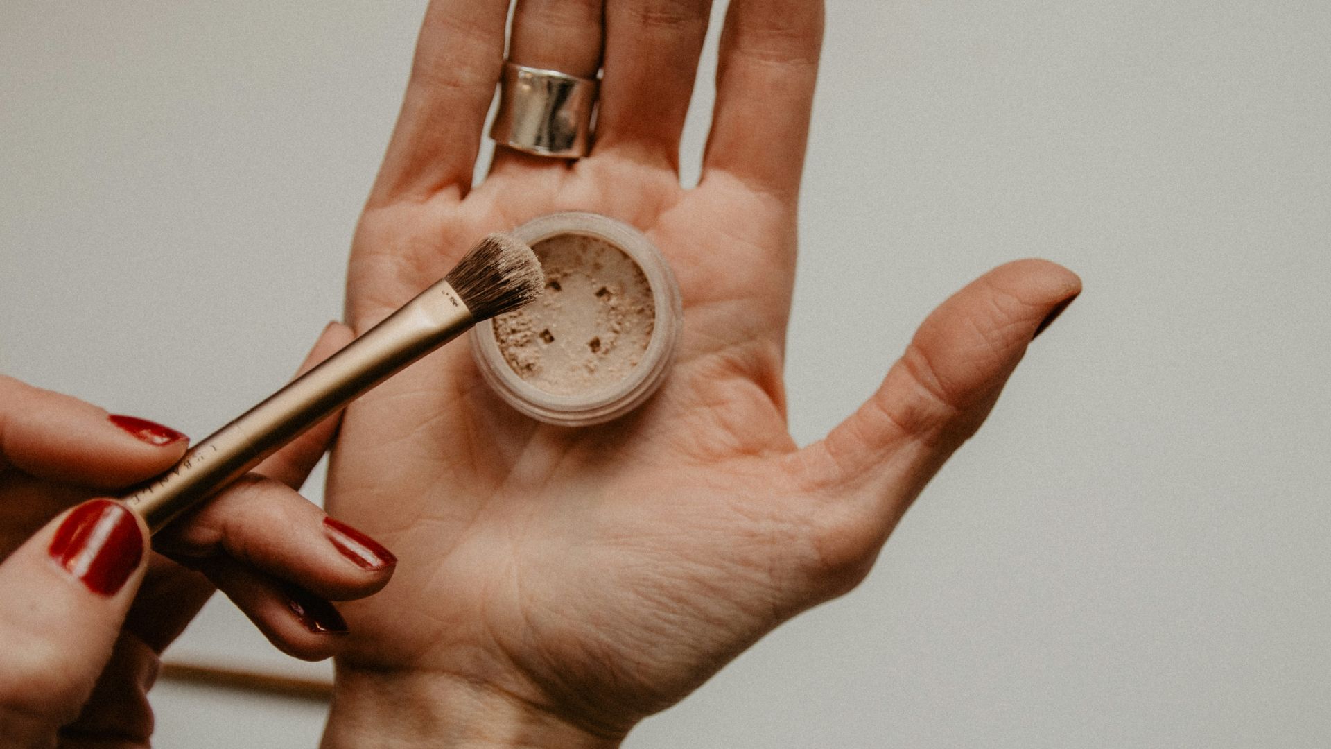 person holding silver round analog watch