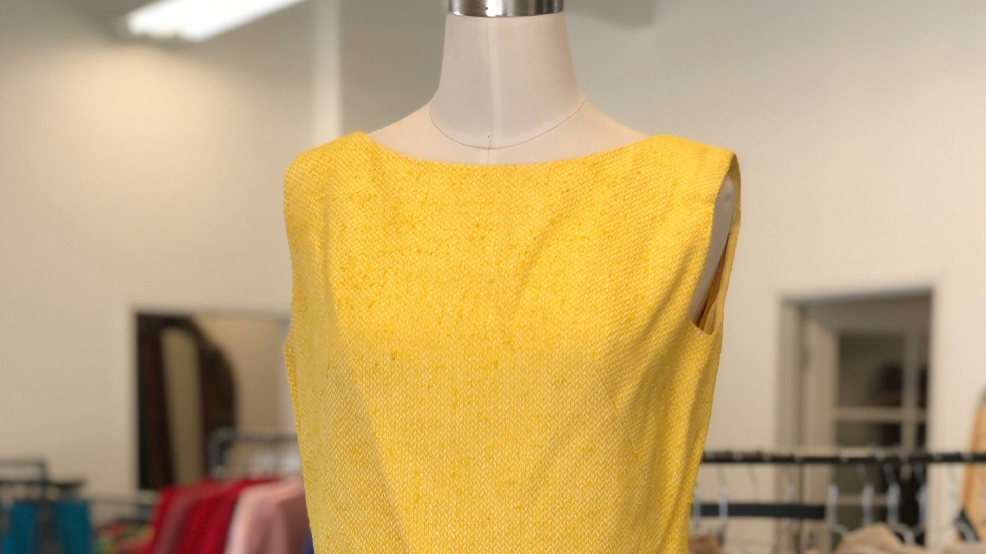a yellow dress on a mannequin in a store
