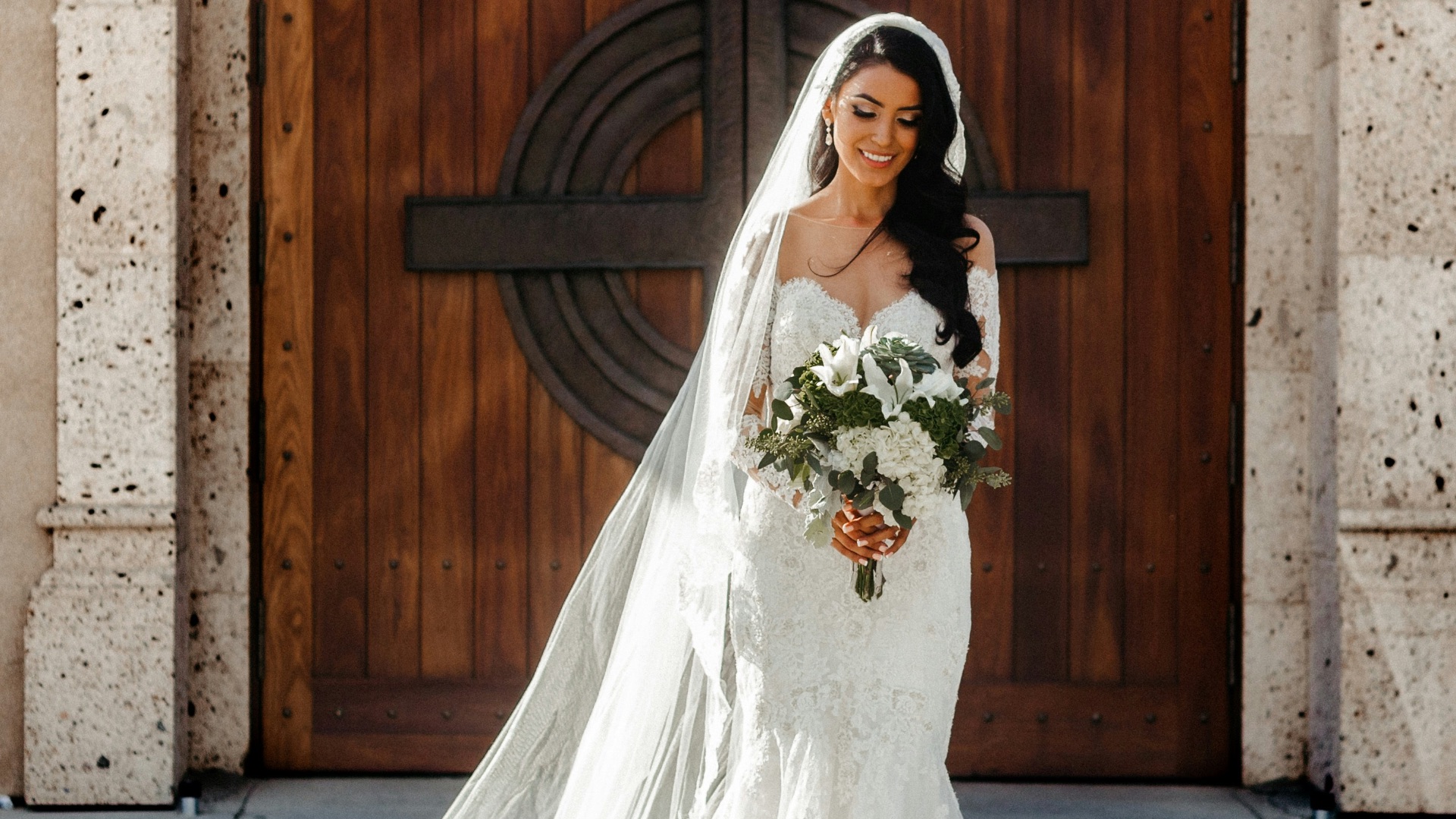 woman wearing wedding dress holding bouquet of flowers