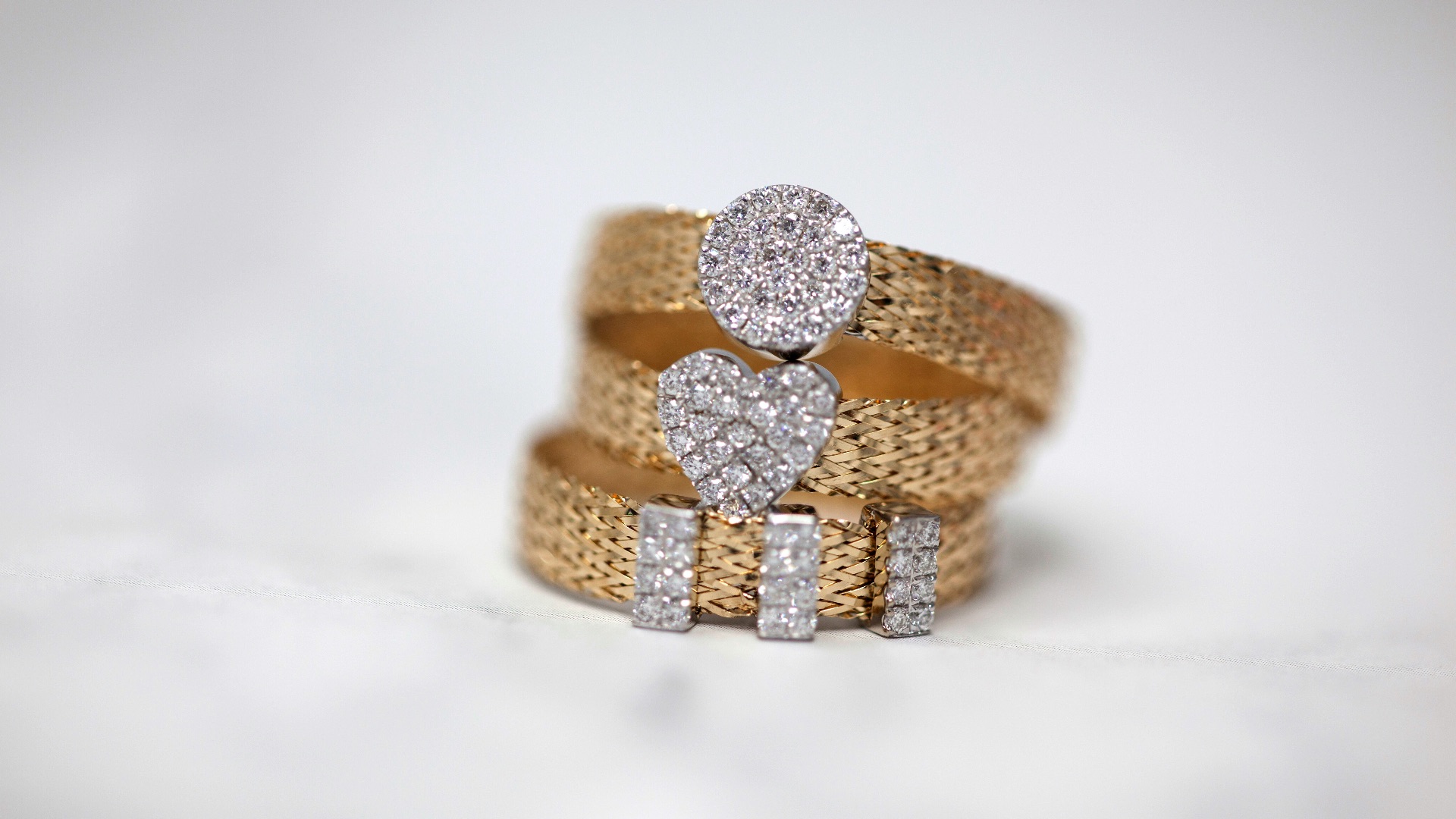 three gold-colored studded rings