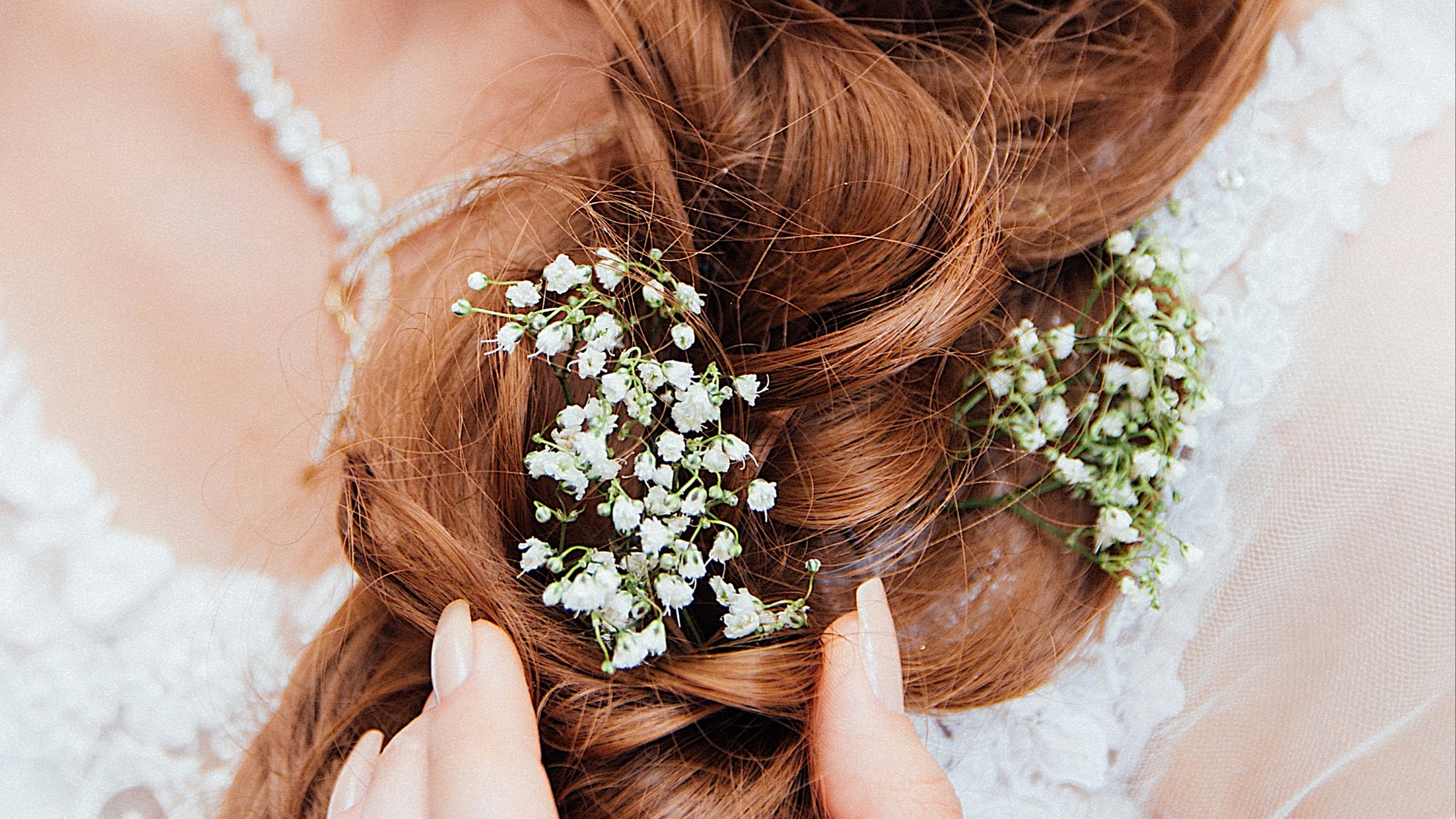 woman holding her hair with flower