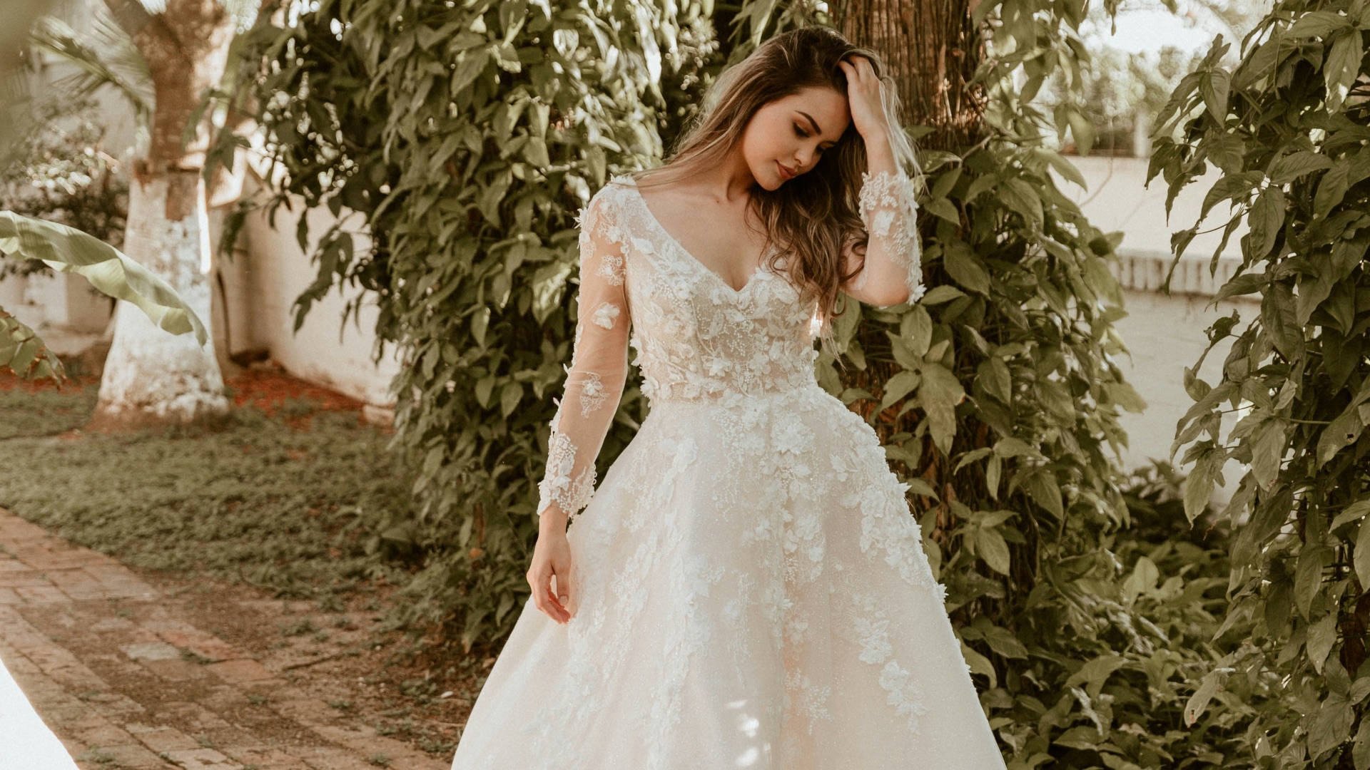 woman in white wedding dress standing near green trees during daytime