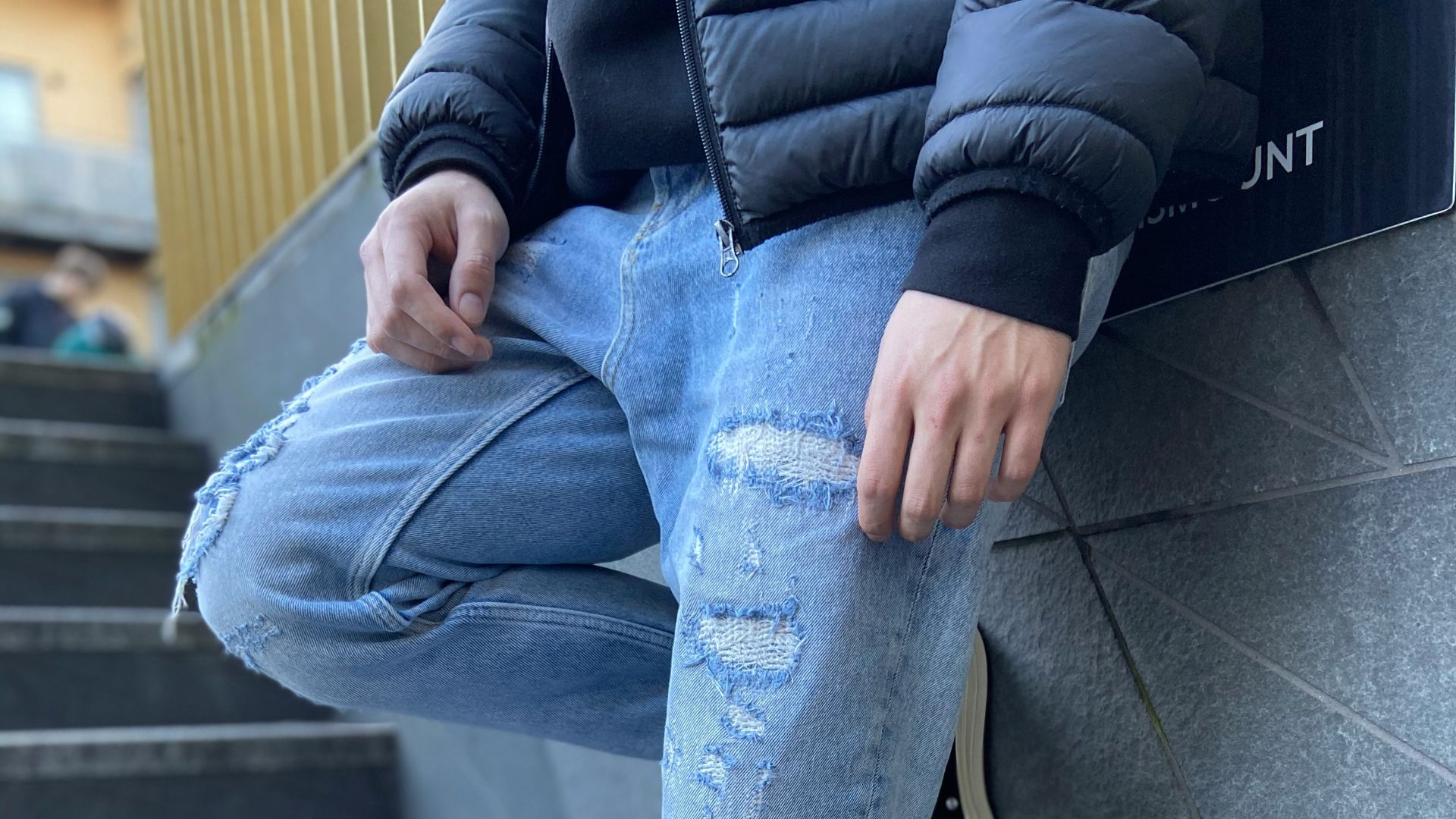 person in blue denim jeans and black and white converse all star high top sneakers