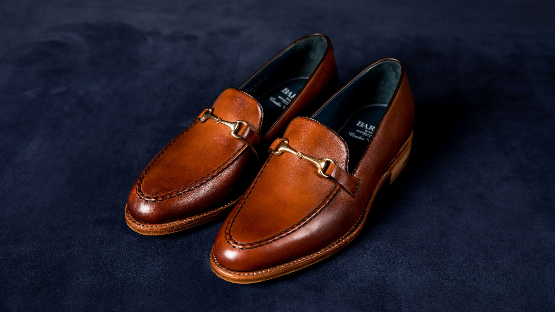 brown leather loafers on blue textile