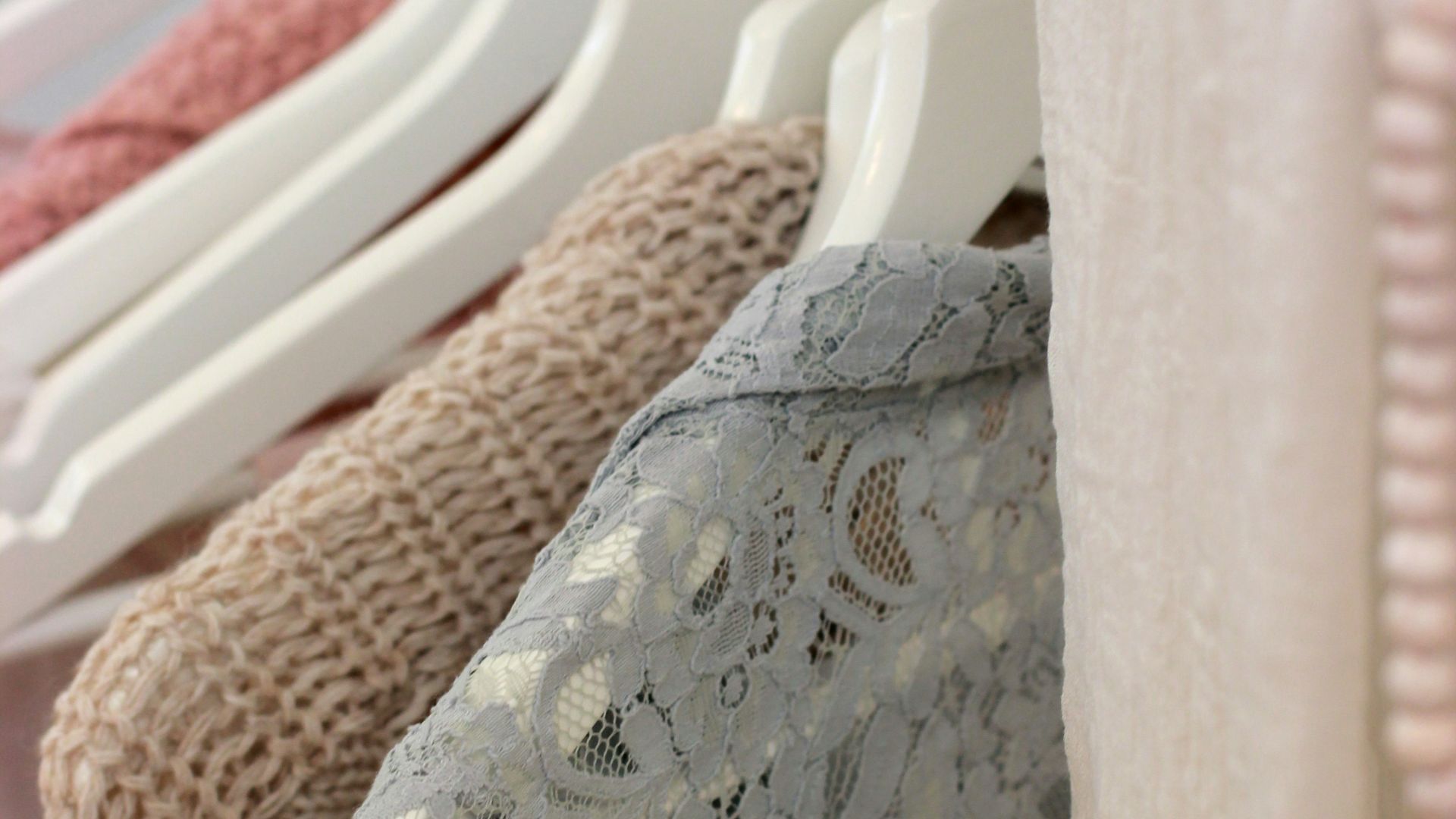 clothes hanging on white rack