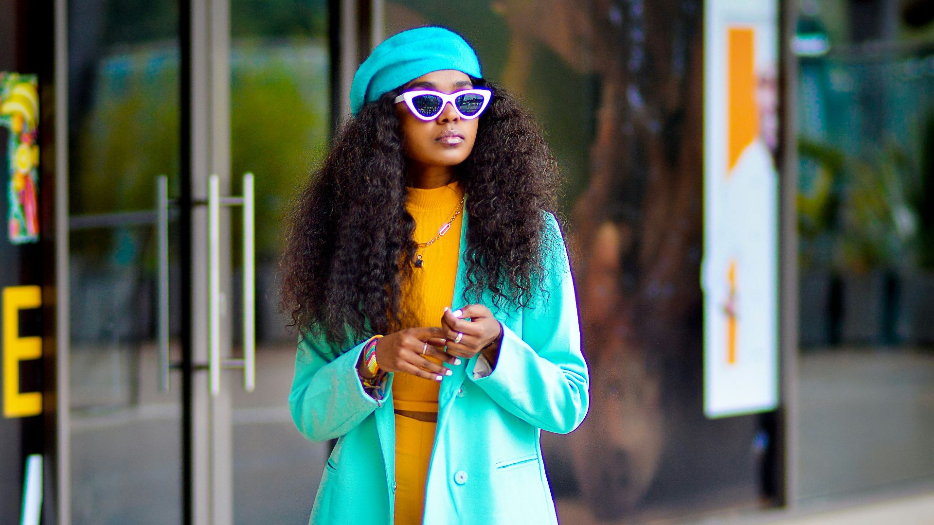 a woman in yellow pants and a blue coat