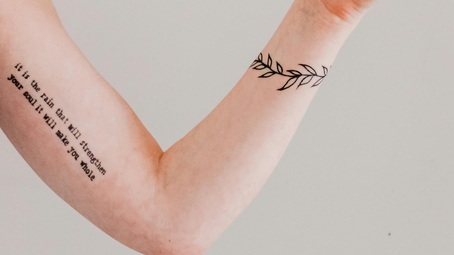 person showing arm and wrist tattoo