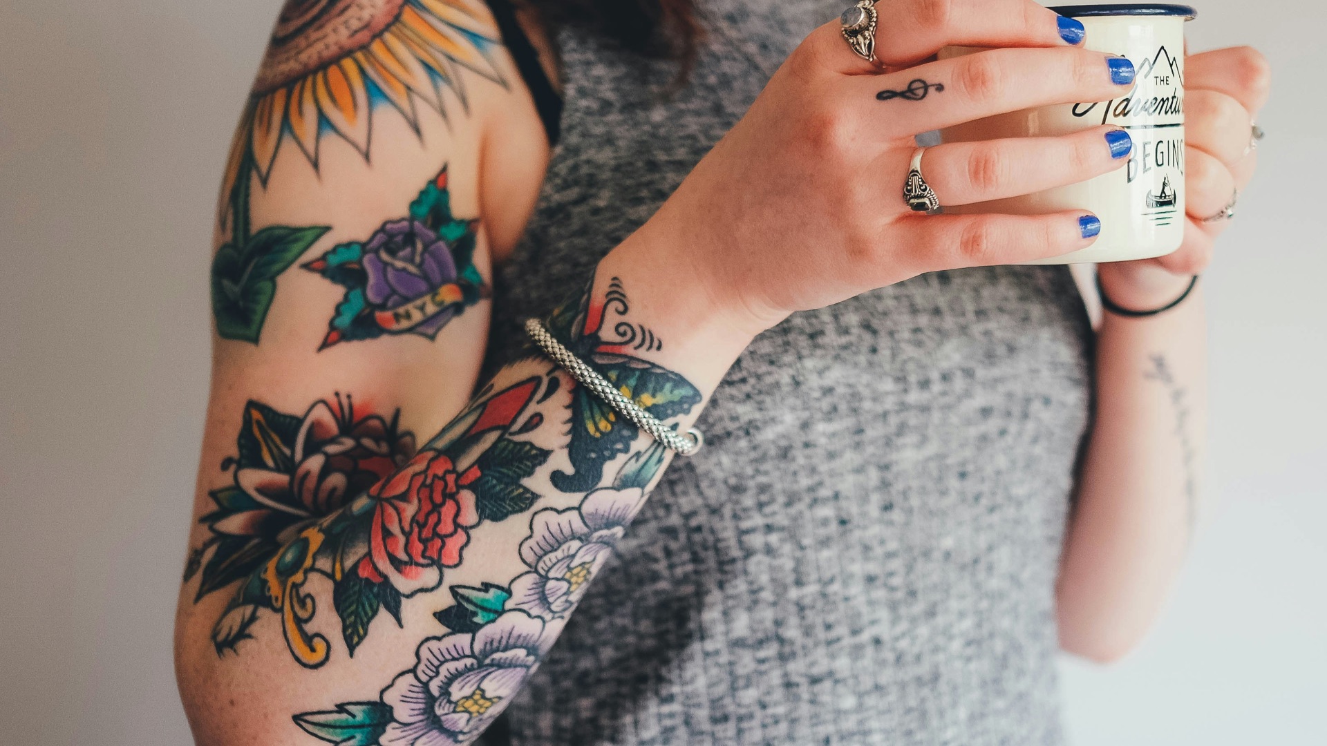 woman holding white ceramic mug