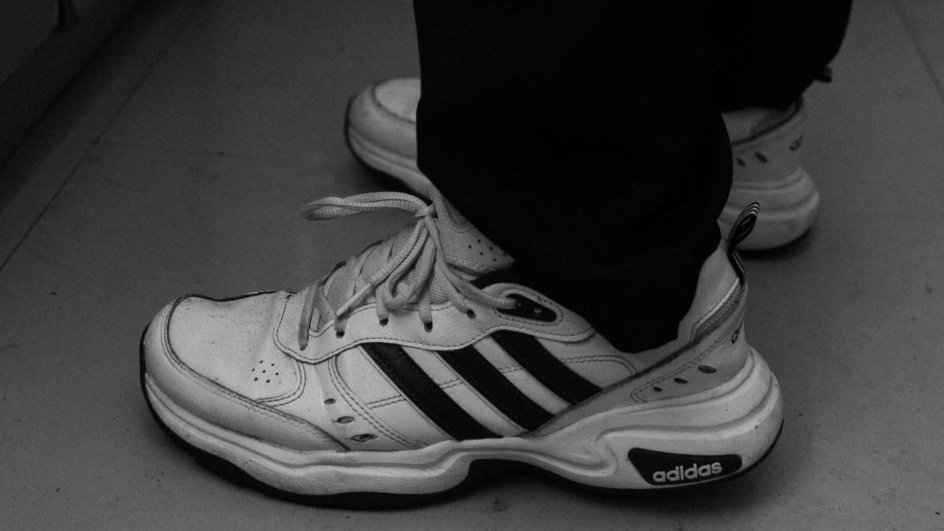 A black and white photo of a person's shoes