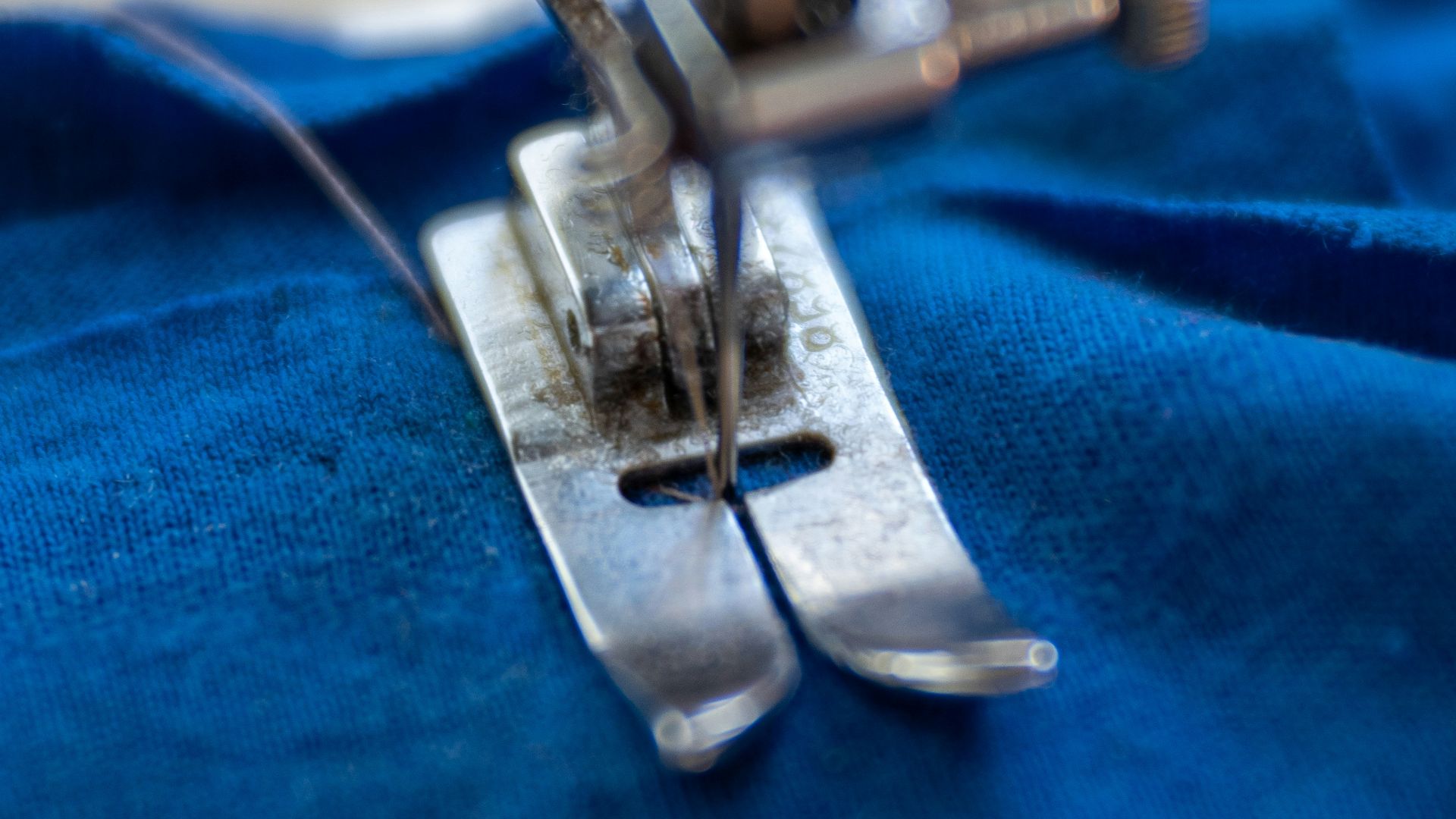 silver sewing machine on blue textile