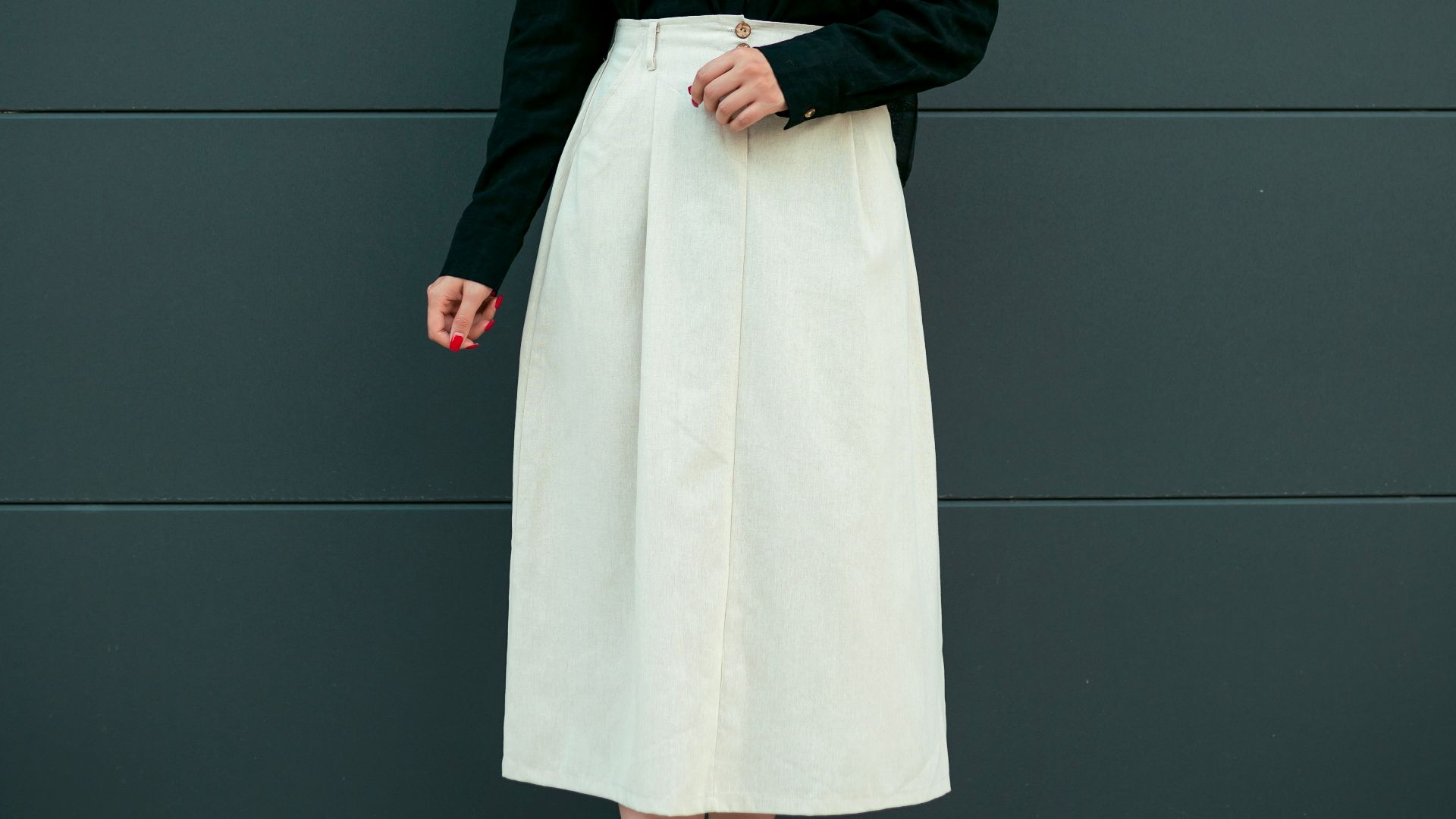 Woman in black headscarf and white skirt