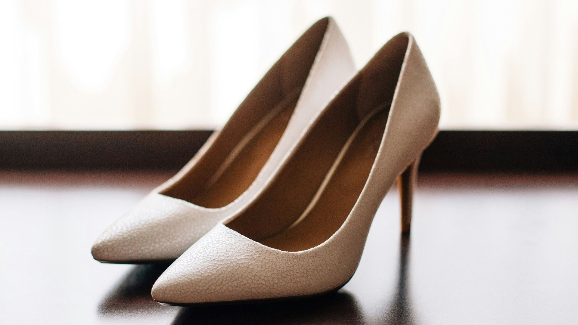 pair of women's brown pointed-toe pumps on board