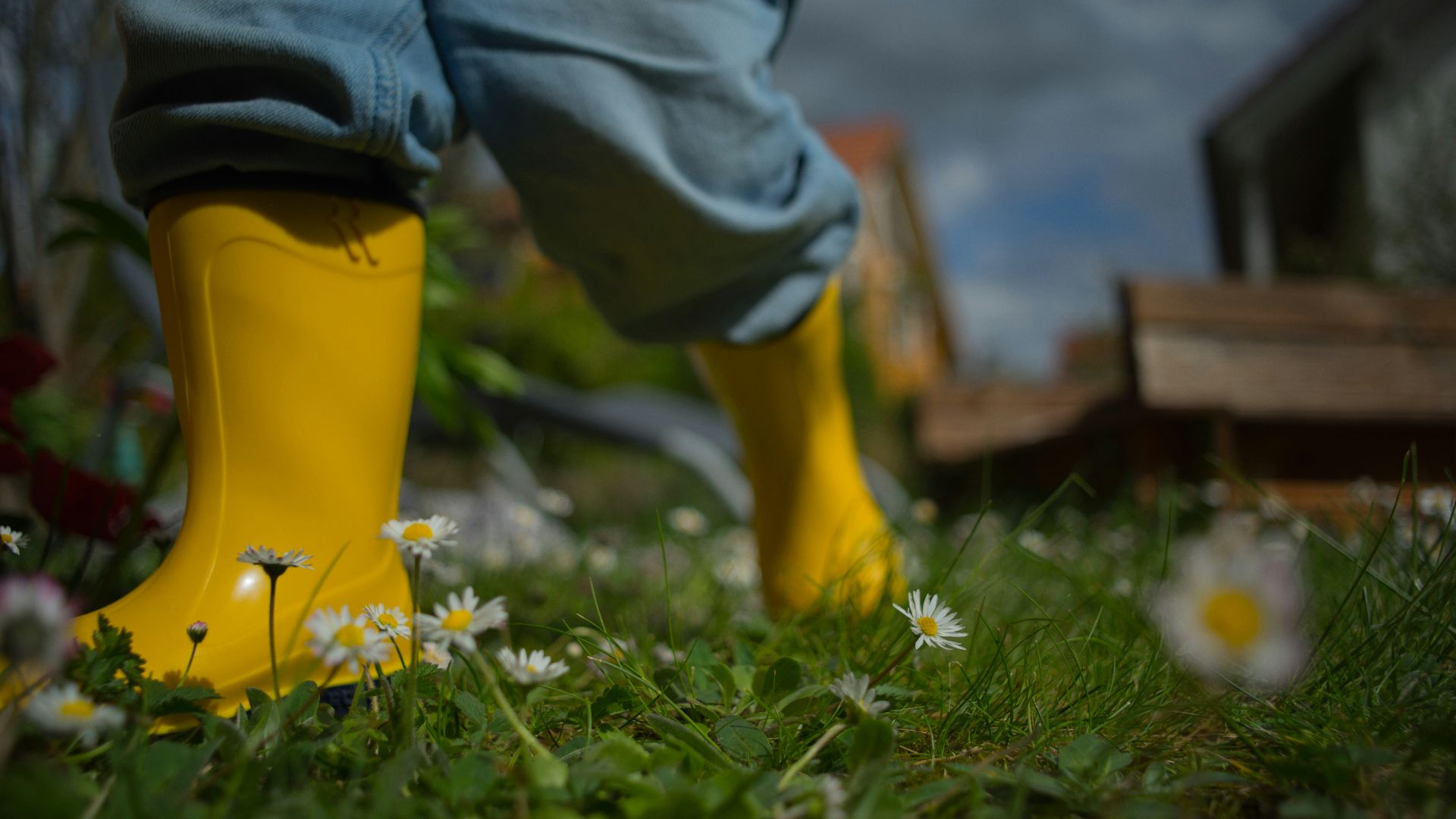 person wearing yellow rain boots during daytime