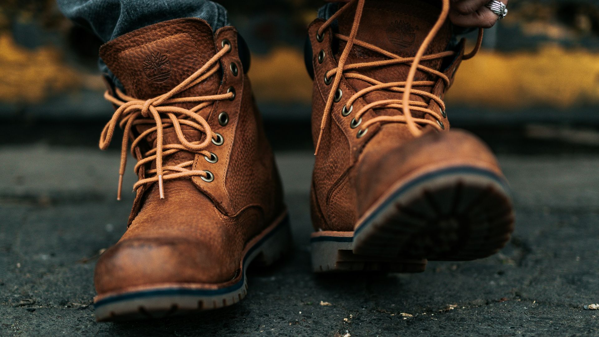 photography of person lacing his/her boots