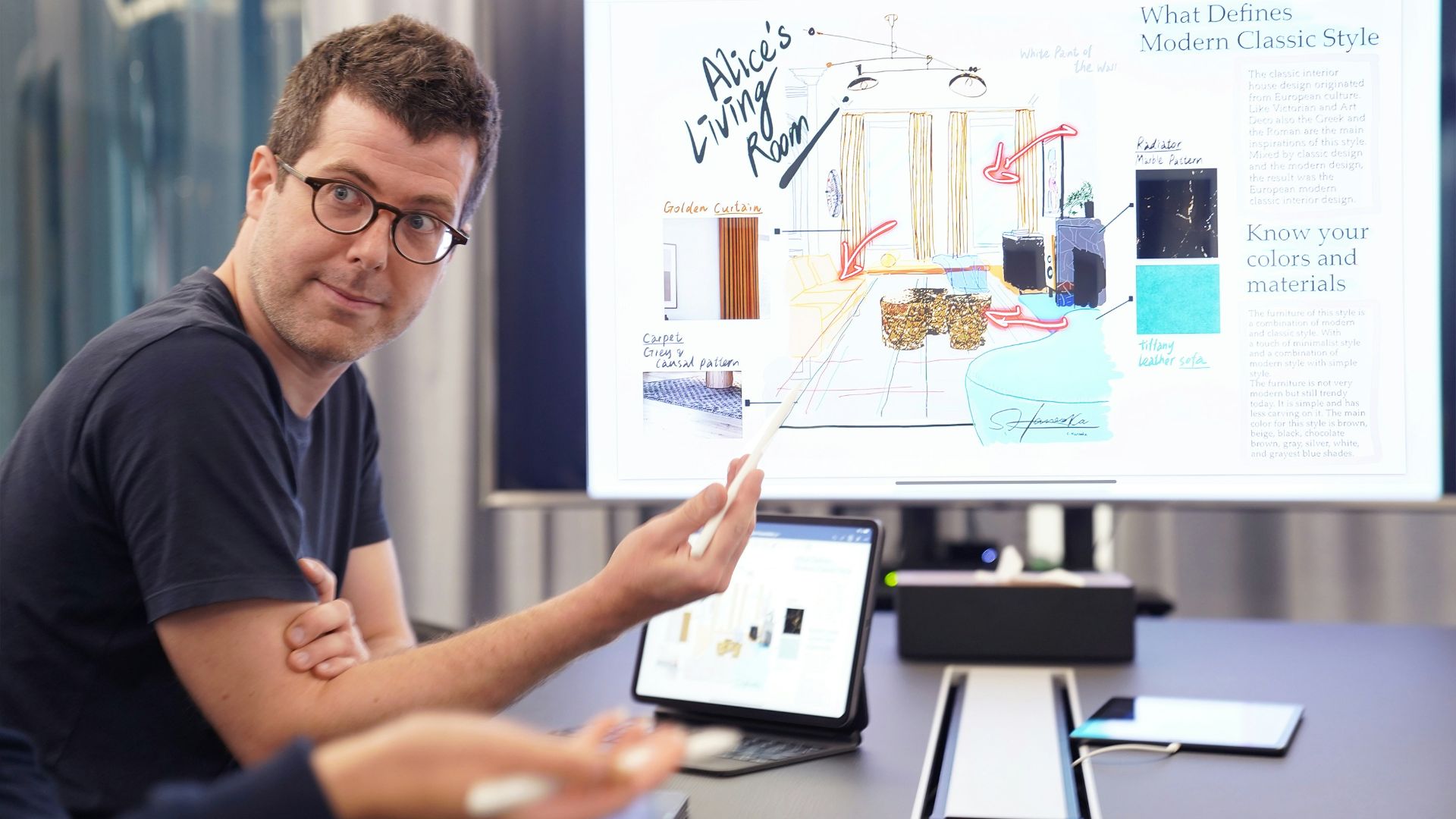 a man sitting at a desk with a laptop and a white board