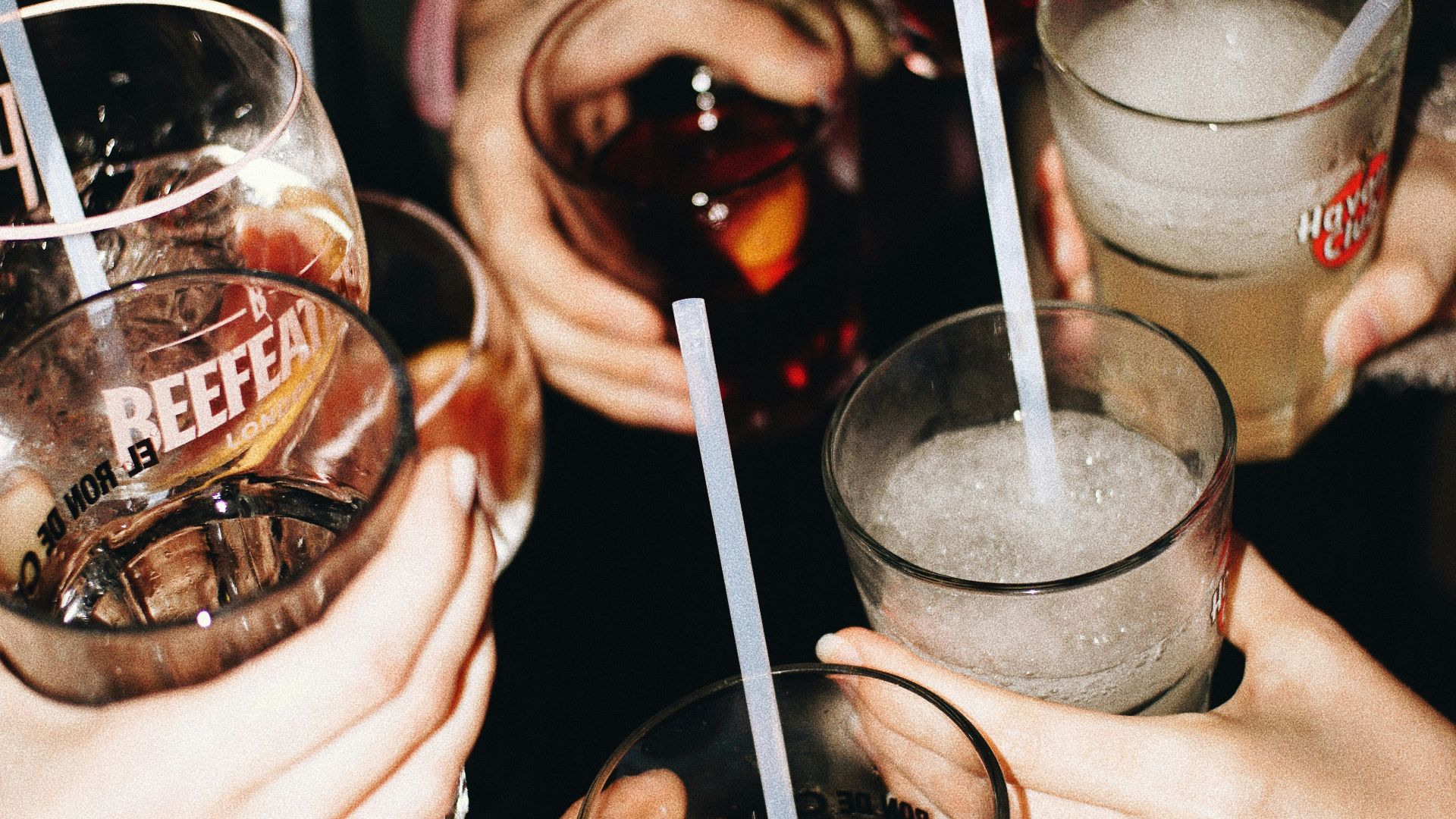 a group of people holding glasses with drinks in them