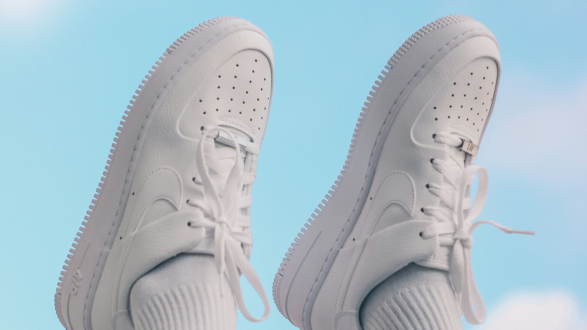 person wearing white nike sneakers