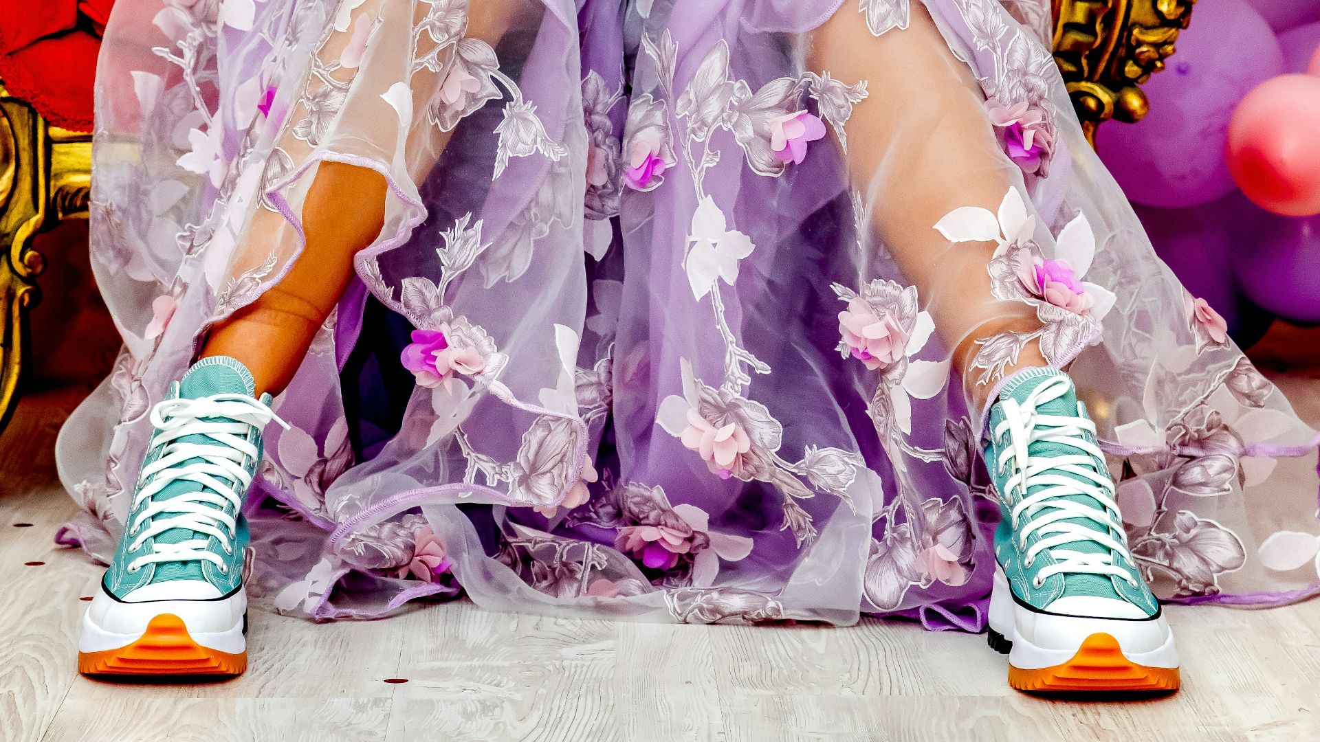 a woman in a purple dress sitting on a red chair