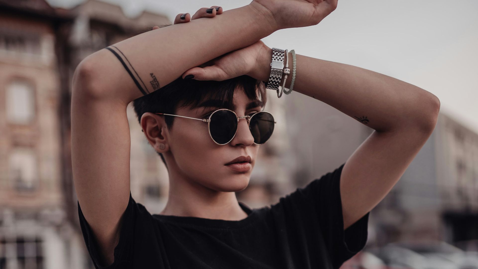 a woman wearing sunglasses and a black top