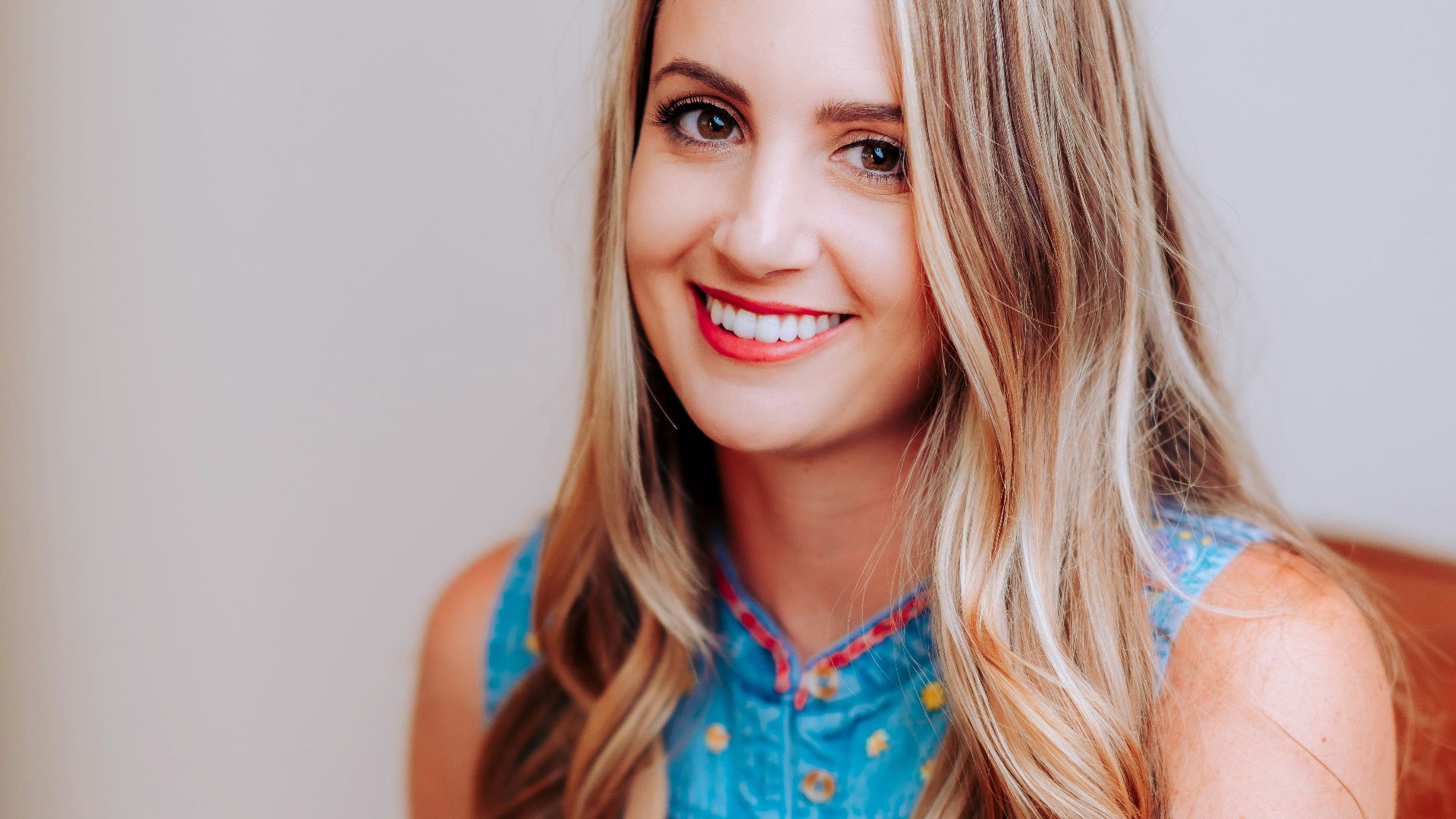 smiling girl in blue sleeveless dress