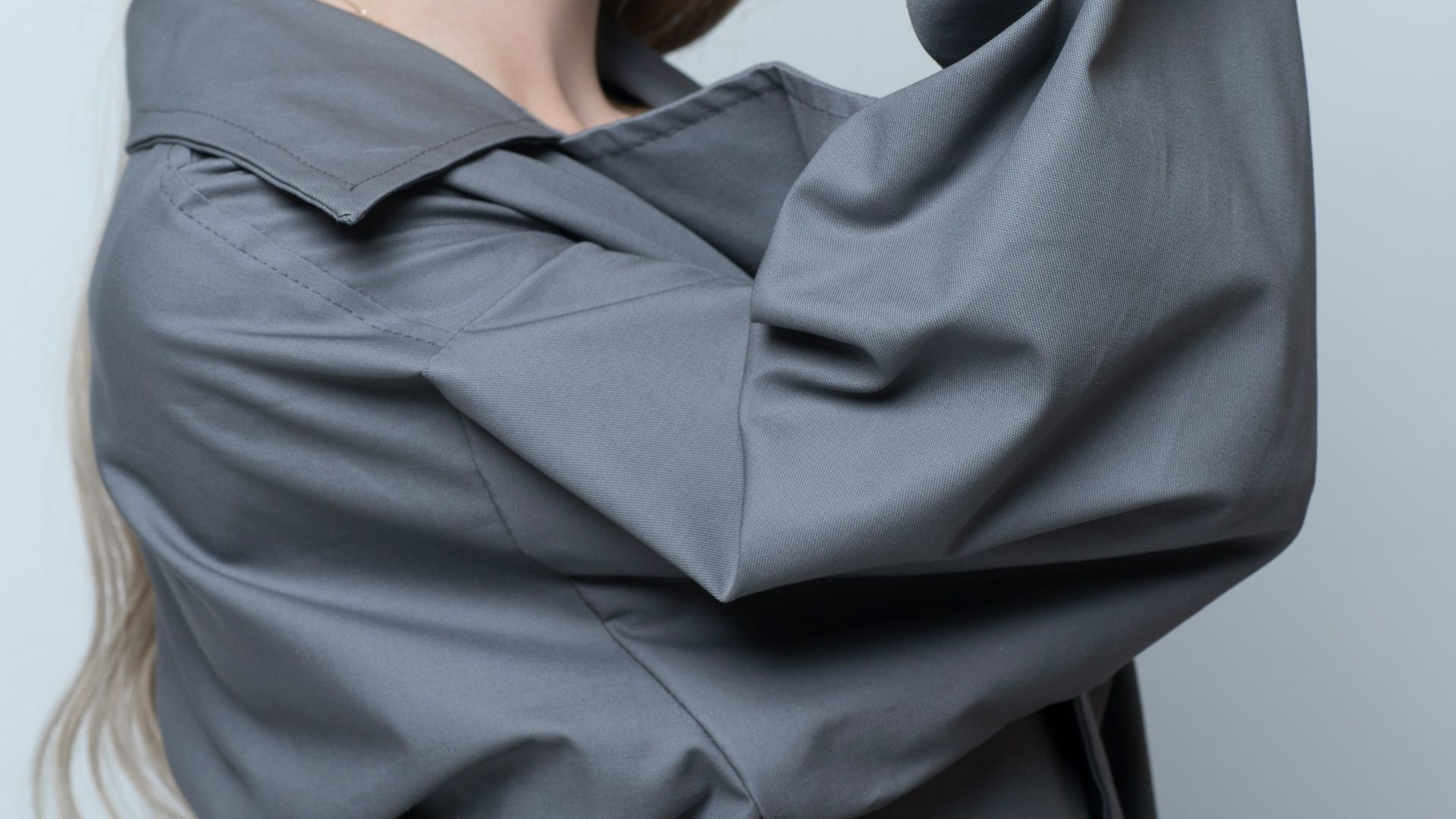 woman in black long sleeve shirt covering her face