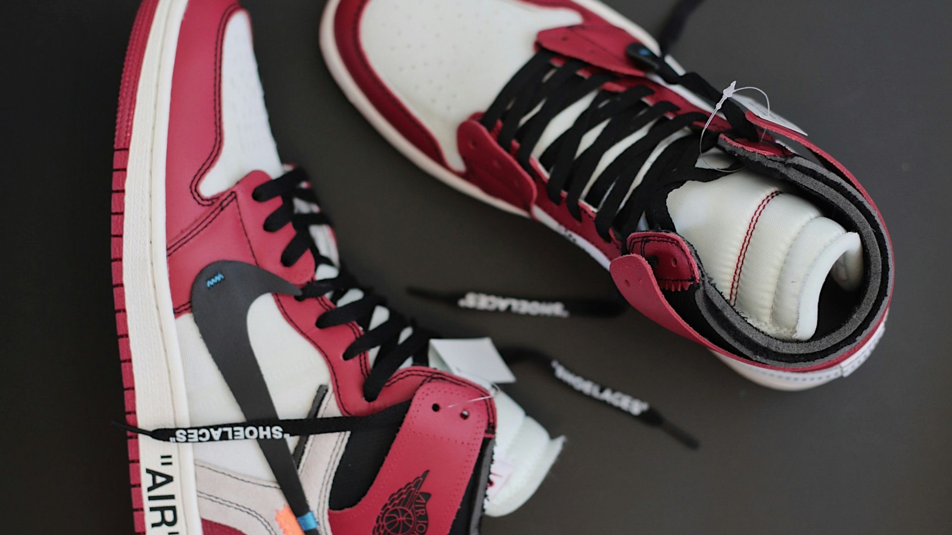 pair of red-white-and-black Nike Air Jordan athletic shoes