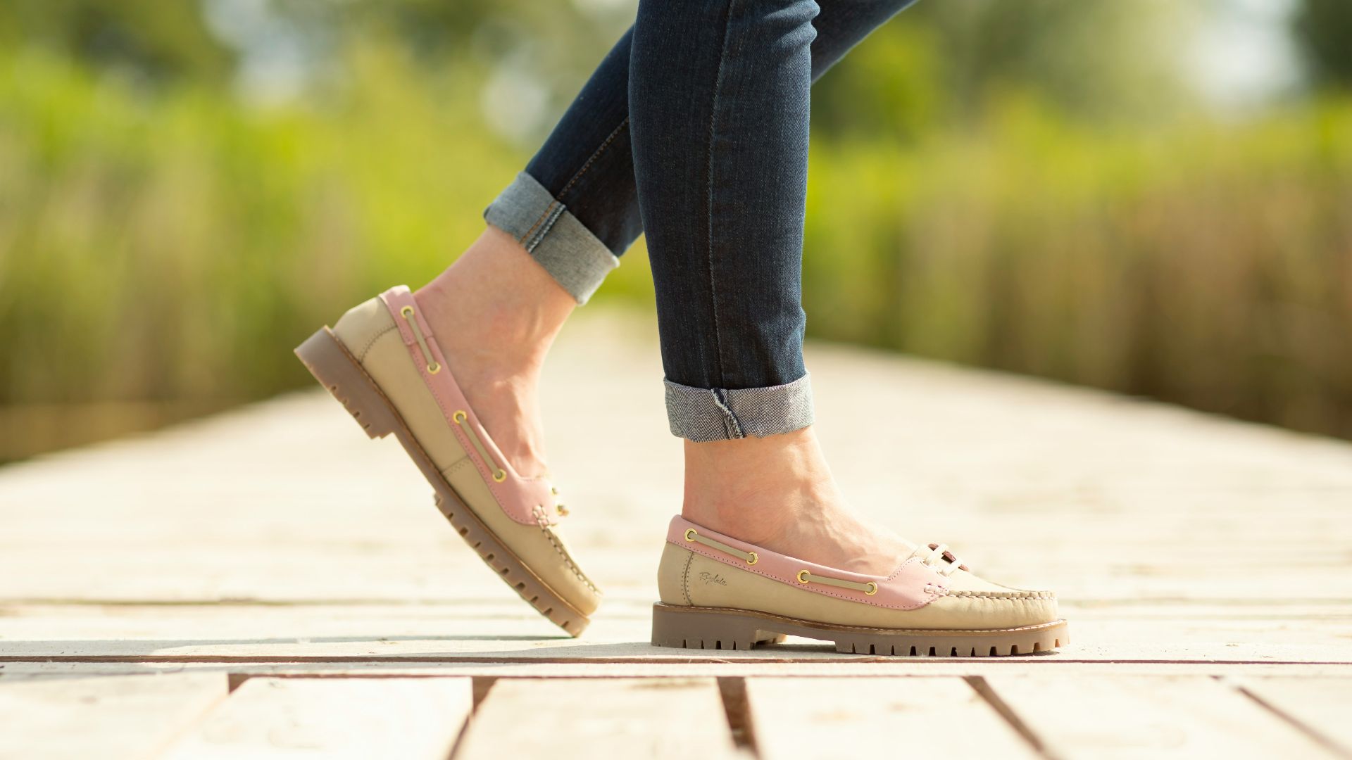 A person walking on a wooden platform in a park