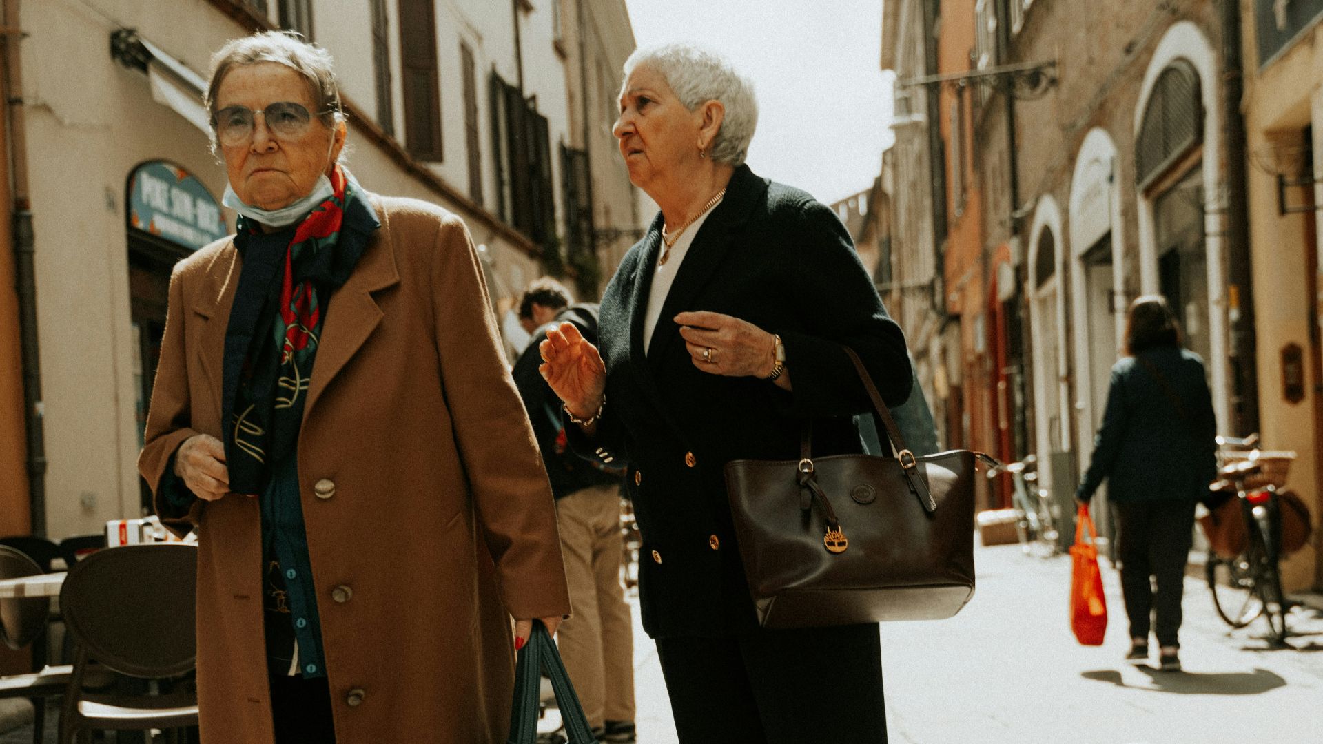 a man and woman walking down a street