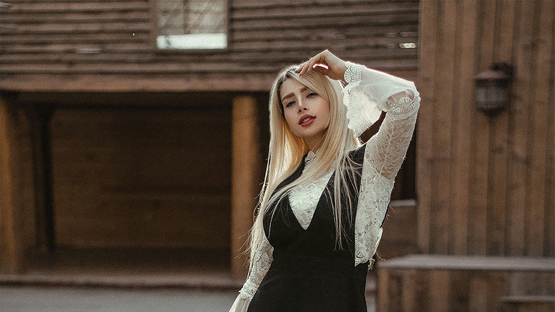 a woman wearing a black dress and white boots