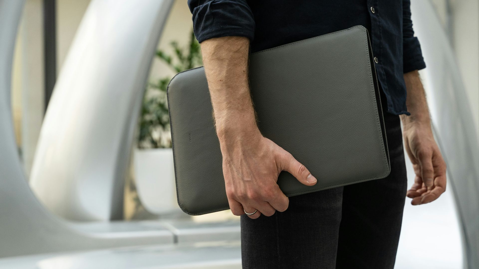 a man holding a laptop in his hand