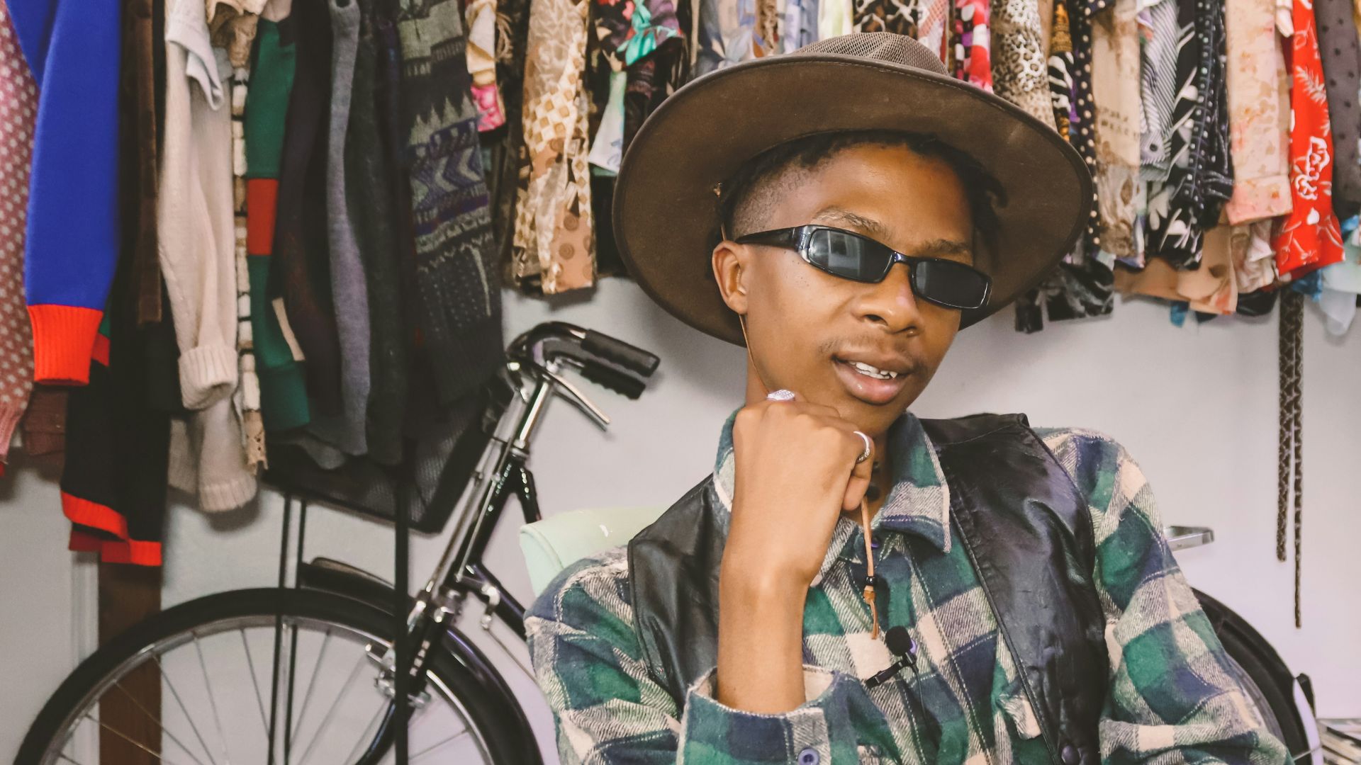 woman in green white and black plaid button up shirt wearing black hat