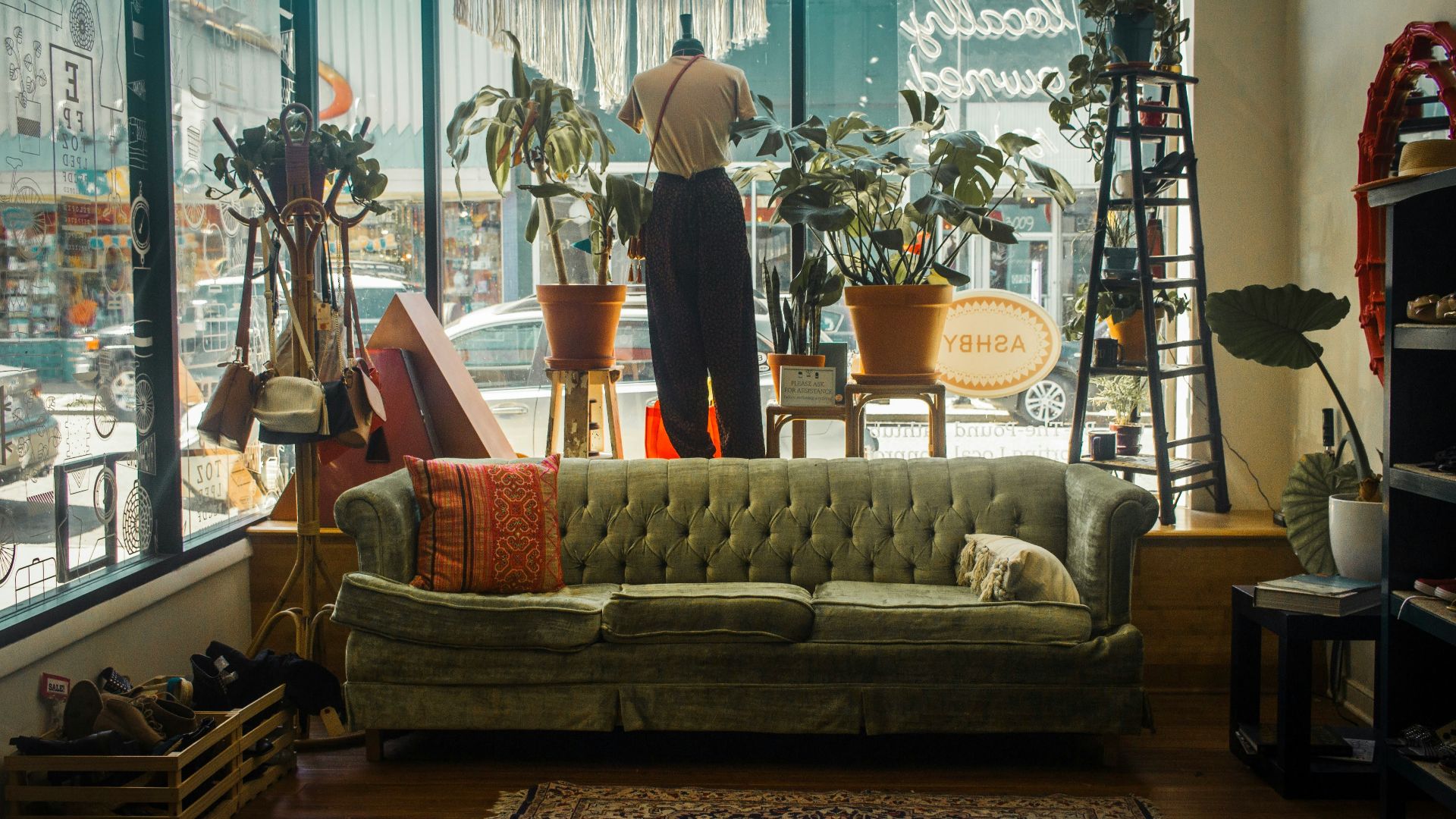 a living room filled with furniture and lots of windows