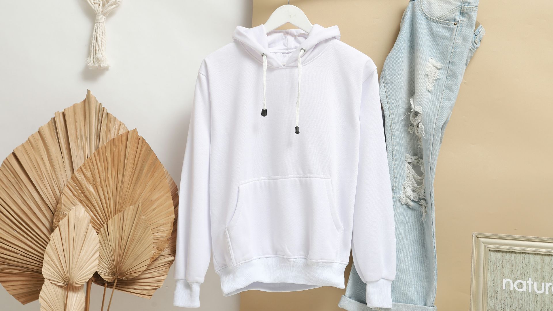 white zip up jacket hanging on brown wooden clothes hanger