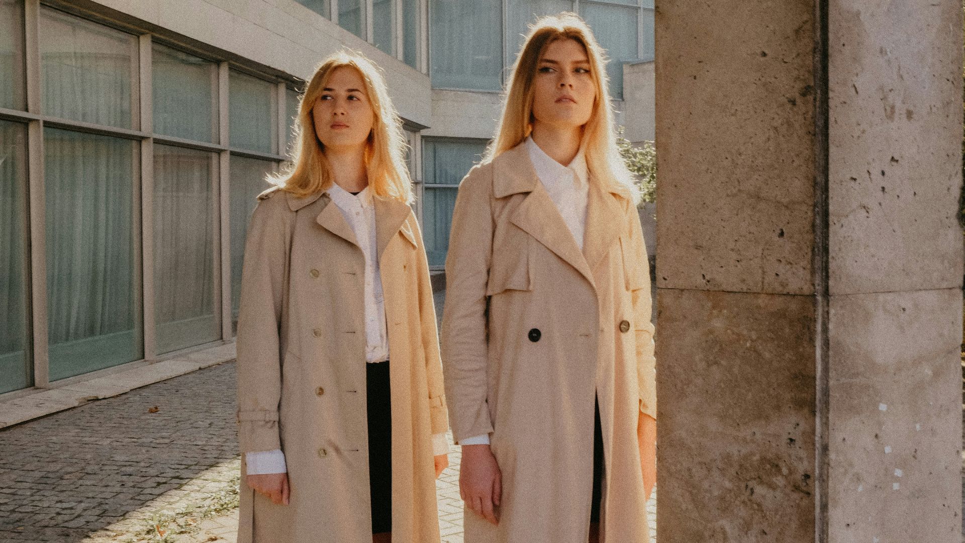 two woman wearing brown coat