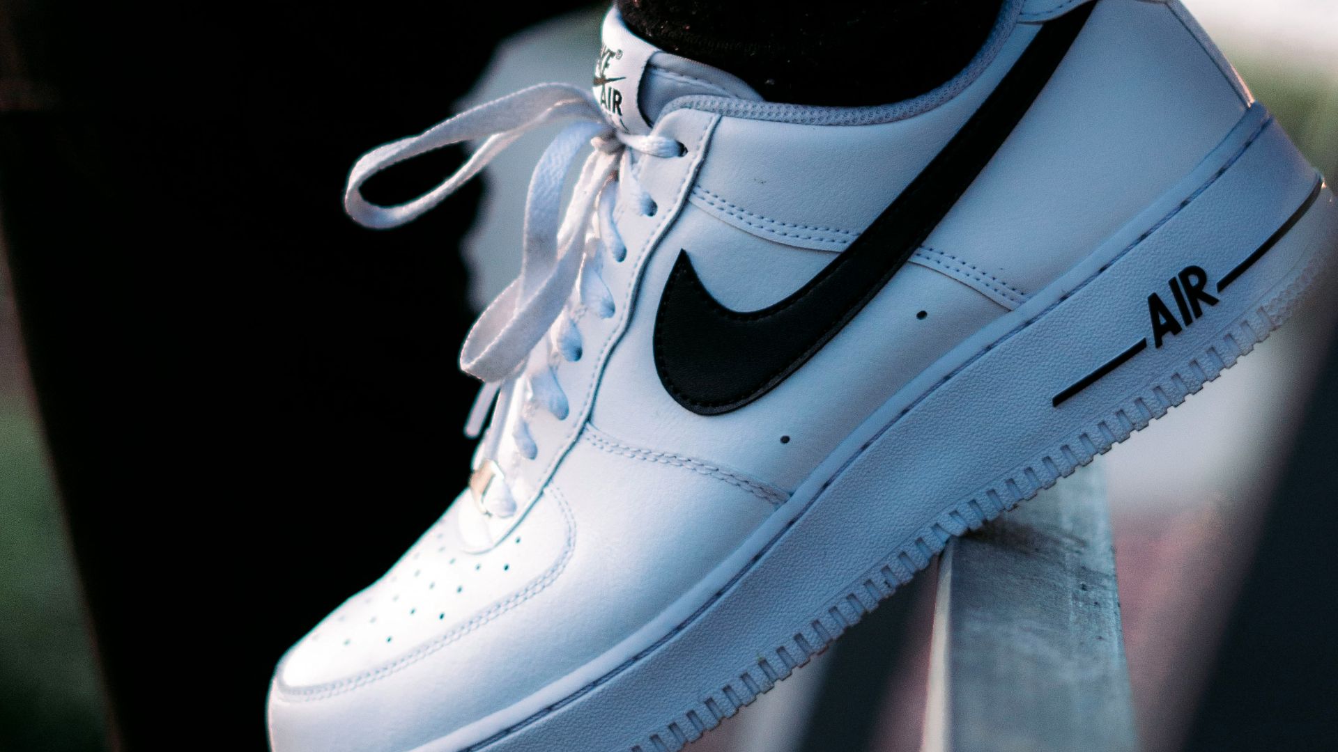 a person wearing a pair of black and white sneakers