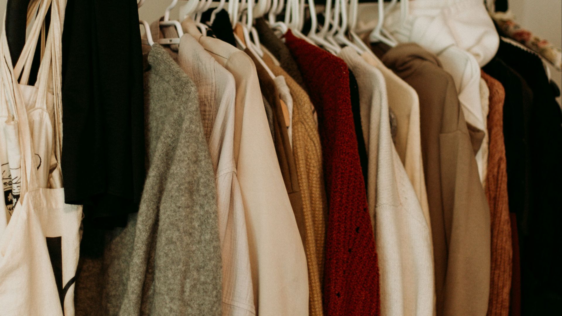 brown and white coat hanged on rack