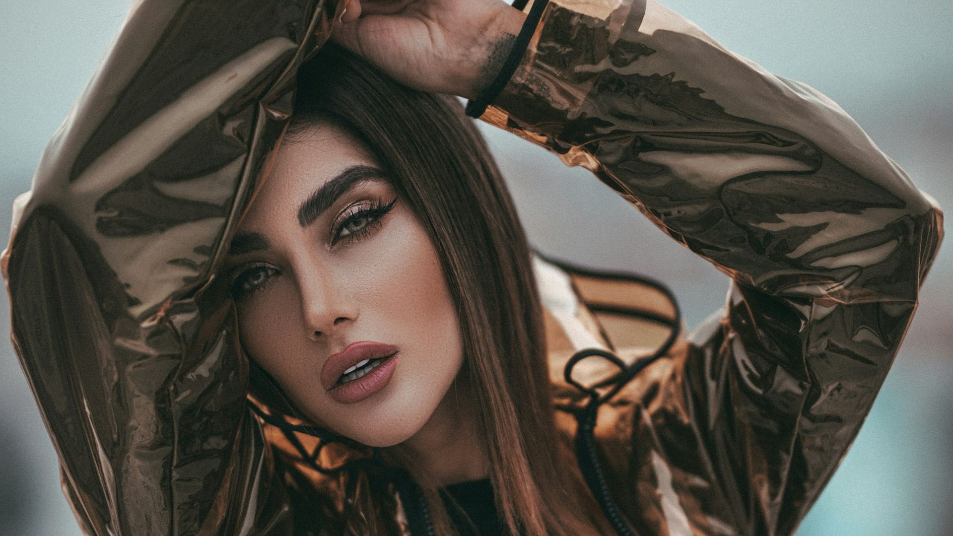 woman standing and putting bot hands on head