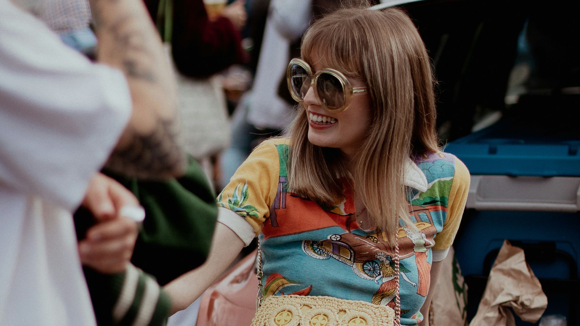 a woman sitting on the back of a car