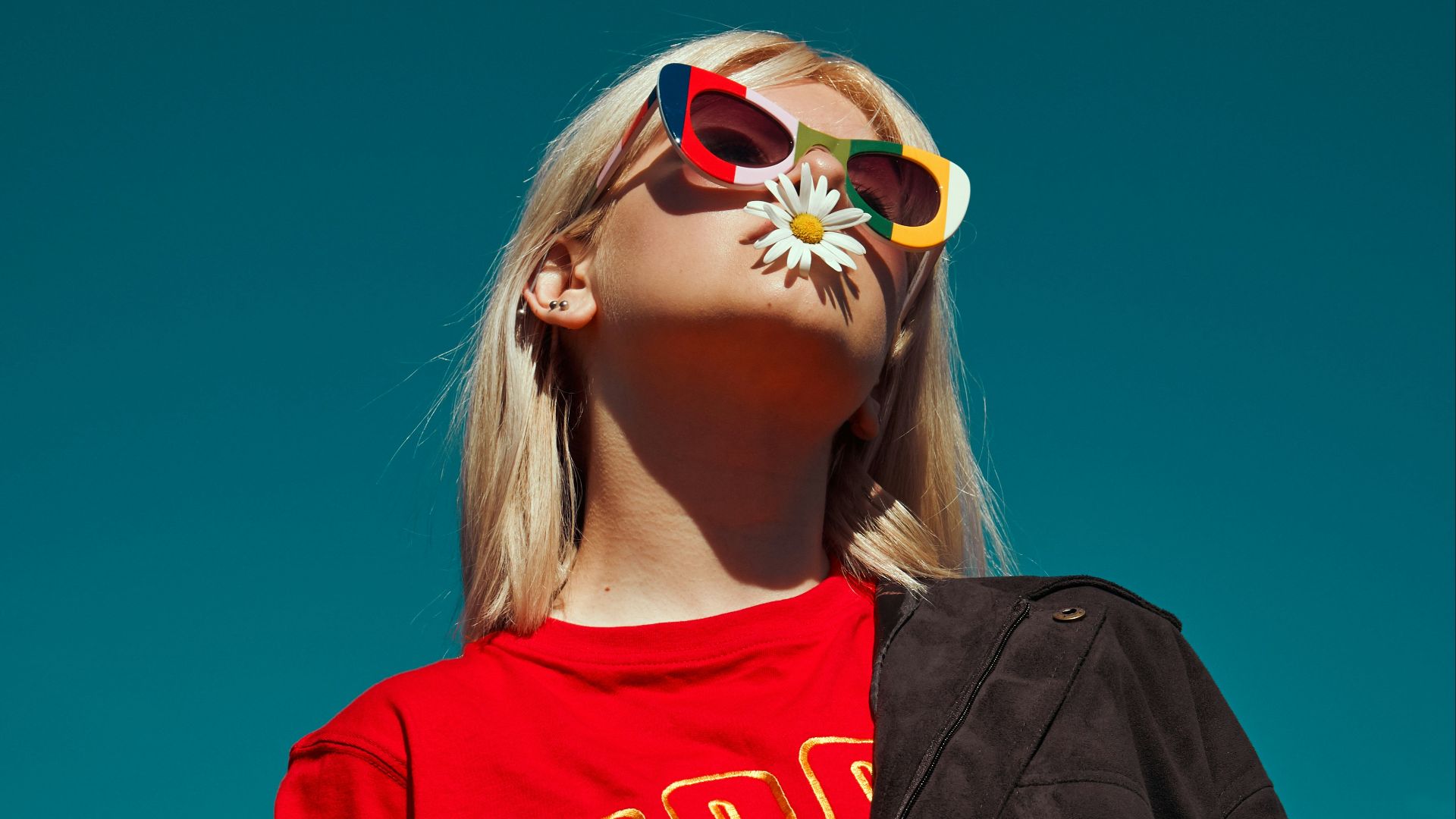 woman with sunglasses standing outdoor during daytime